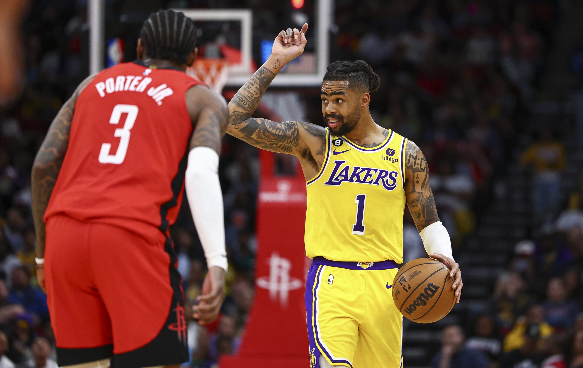 Mar 15, 2023; Houston, Texas, USA; Los Angeles Lakers guard D'Angelo Russell (1) brings the ball up the court as Houston Rockets guard Kevin Porter Jr. (3) defends during the third quarter at Toyota Center. Mandatory Credit: Troy Taormina-USA TODAY Sports