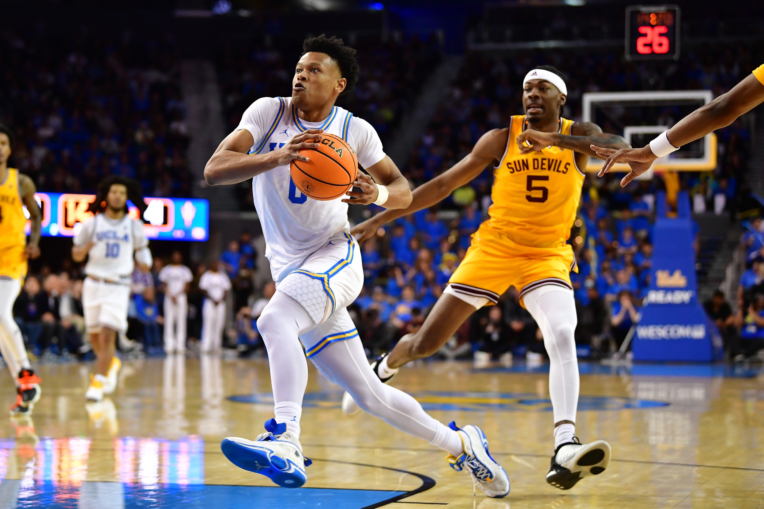 Mar 2, 2023; Los Angeles, California, USA; UCLA Bruins guard Jaylen Clark (0) moves to the basket ahead of Arizona State Sun Devils forward Jamiya Neal (5) during the second half at Pauley Pavilion. Mandatory Credit: Gary A. Vasquez-USA TODAY Sports