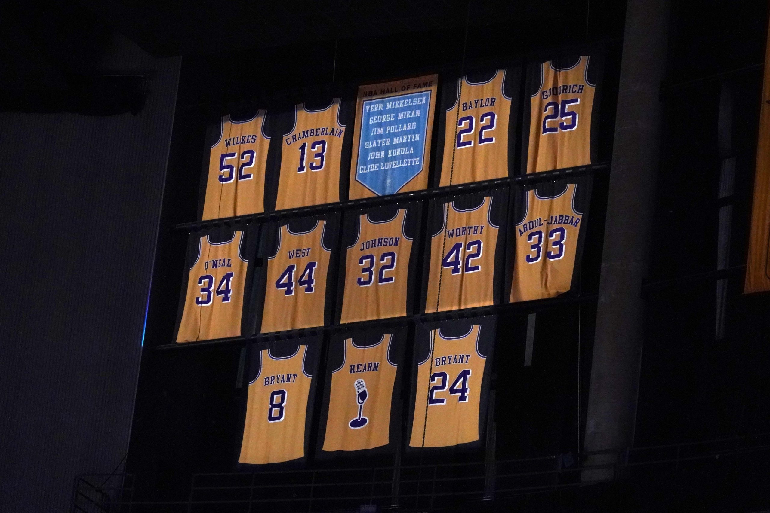 Feb 26, 2021; Los Angeles, California, USA; The retired Los Angeles Lakers jerseys of Jamaal Wilkes (52), Wilt Chamberlain (13), Elgin Baylor (22), Gail Goodrich (25), Shaquille O'Neal (34), Jerry West (44), Magic Johnson (32), James Worthy (42), Kareem Abdul-Jabbar (33), Chick Hearn and Kobe Bryant (8) and (24)at Staples Center. Mandatory Credit: Kirby Lee-USA TODAY Sports