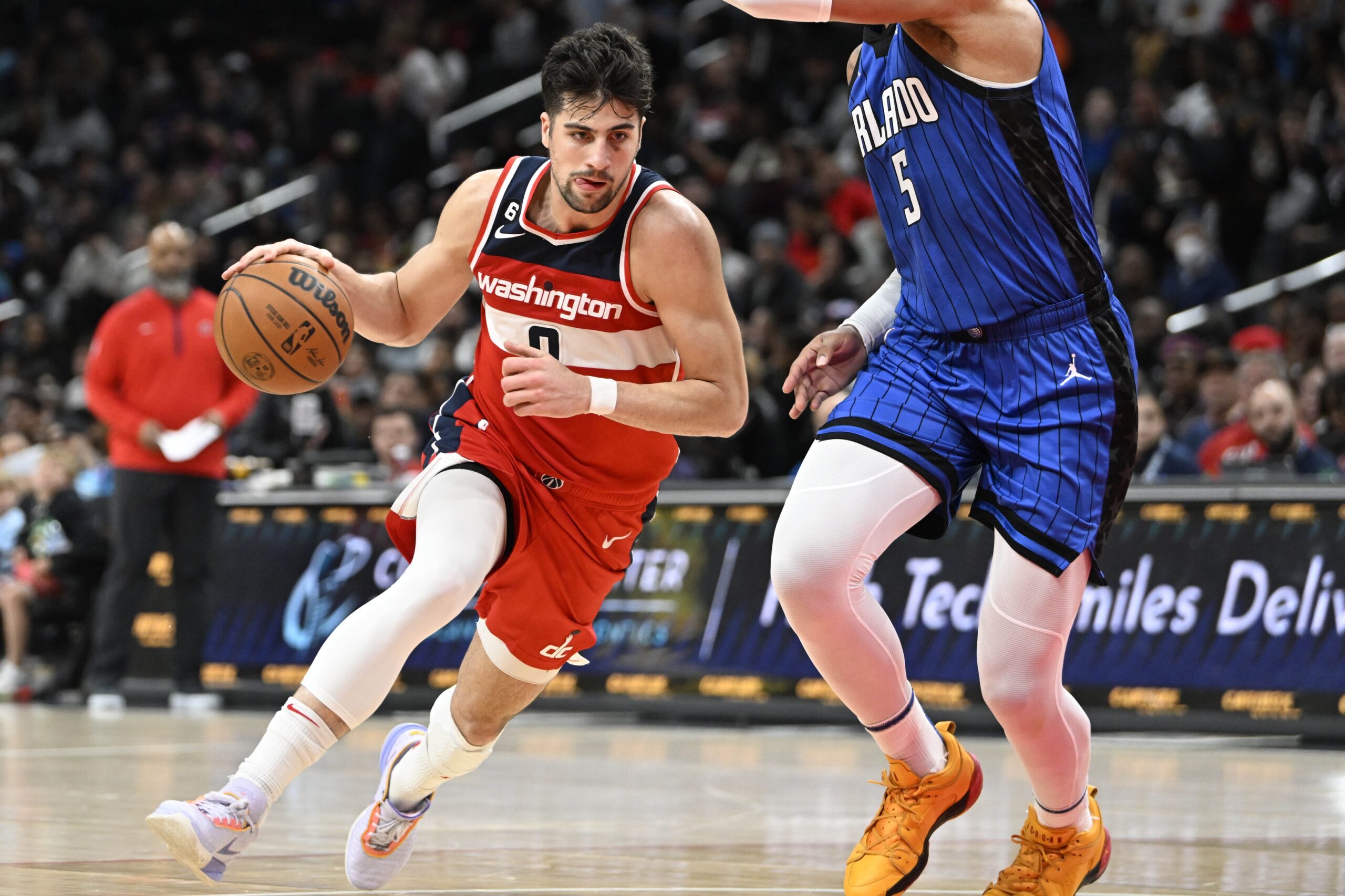 Mar 31, 2023; Washington, District of Columbia, USA; Washington Wizards forward Deni Avdija (9) dribbles as Orlando Magic forward Paolo Banchero (5) defends during the second half at Capital One Arena. Mandatory Credit: Brad Mills-USA TODAY Sports