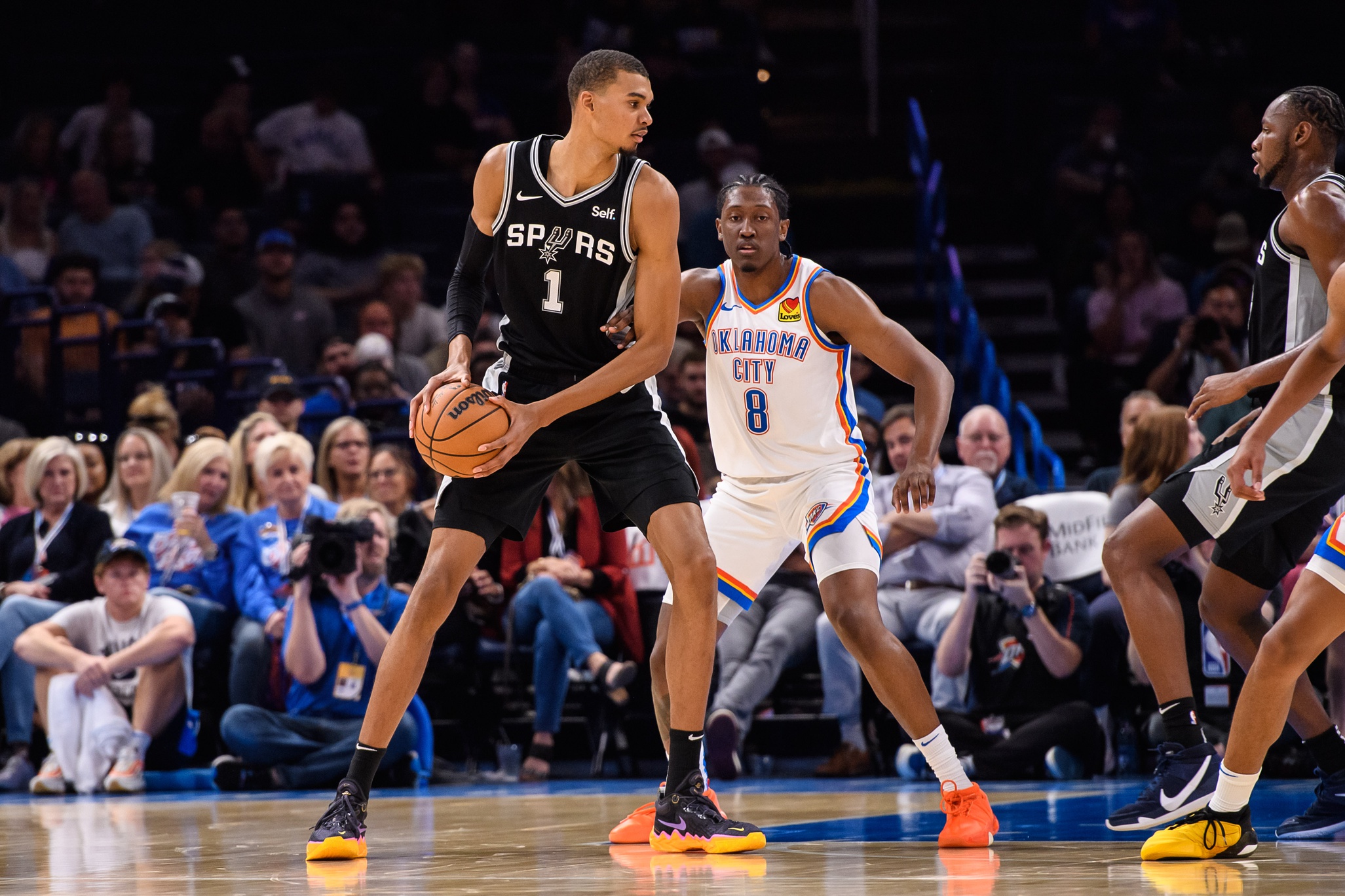 Oct 9, 2023; Oklahoma City, Oklahoma, USA; San Antonio Spurs center Victor Wembanyama (1) with the ball while defended by Oklahoma City Thunder forward Jalen Williams (8) during the first half at Paycom Center. Mandatory Credit: Rob Ferguson-USA TODAY Sports