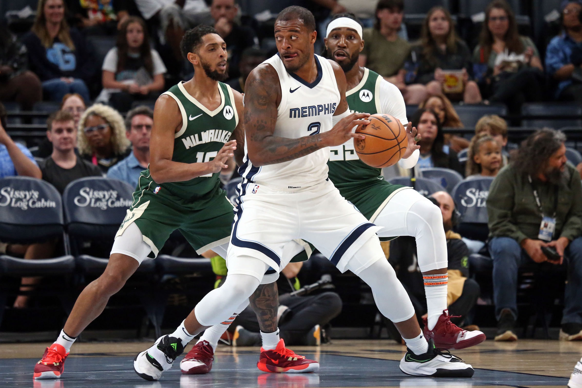 Oct 10, 2023; Memphis, Tennessee, USA; Memphis Grizzlies forward Xavier Tillman (2) as Milwaukee Bucks guard Cameron Payne (15) defends during the first half at FedExForum. Mandatory Credit: Petre Thomas-USA TODAY Sports