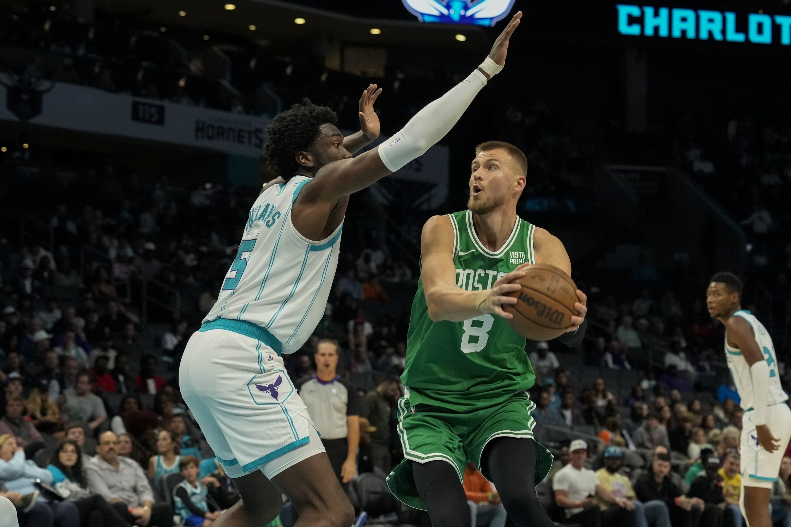 Oct 19, 2023; Charlotte, North Carolina, USA; Boston Celtics center Kristaps Porzingis (8) looks to shoot guarded by Charlotte Hornets center Mark Williams (5) during the second quarter at Spectrum Center. Mandatory Credit: Jim Dedmon-USA TODAY Sports