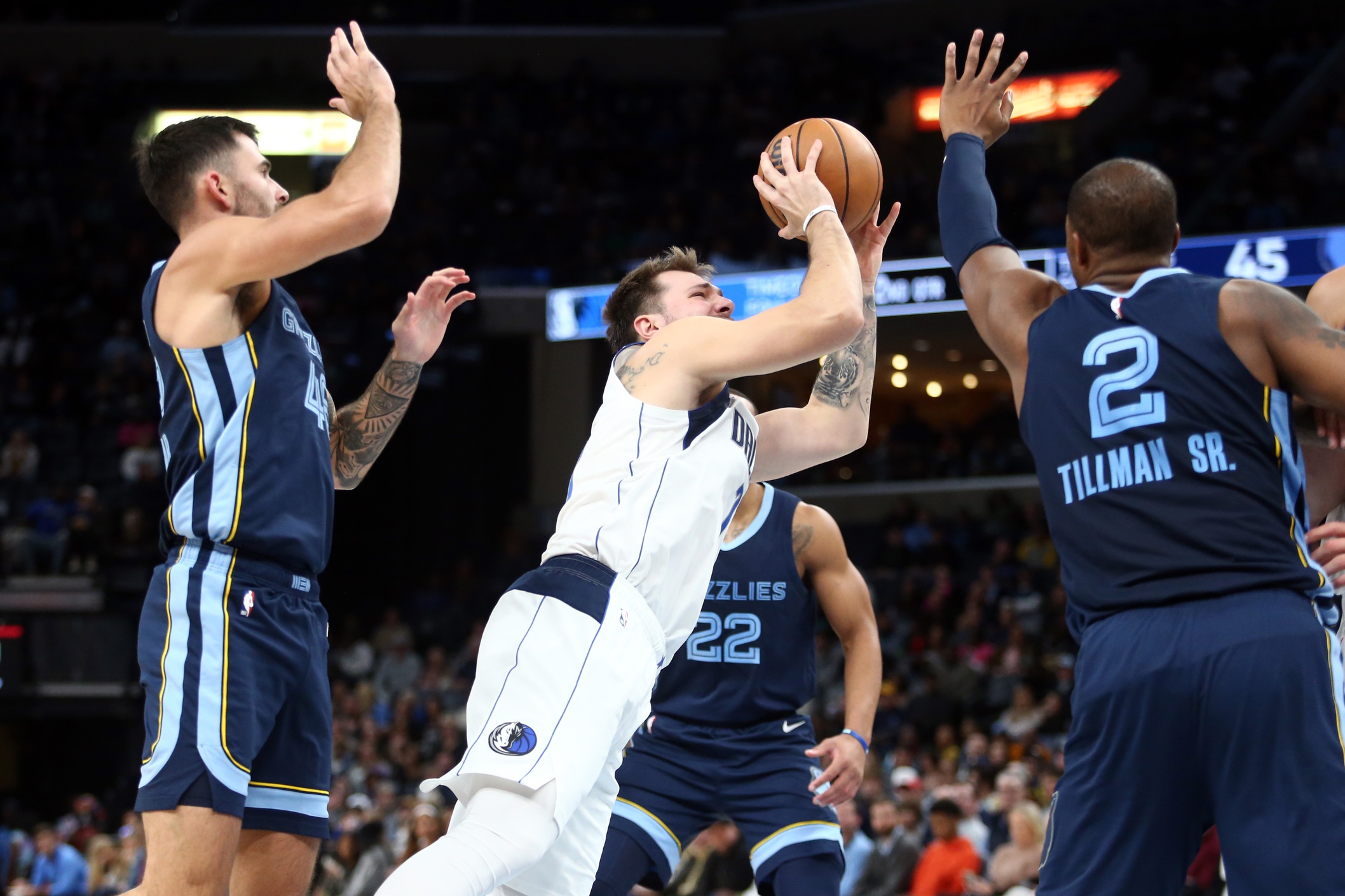 Dallas Mavericks guard Luka Doncic (77) shoots as Memphis Grizzlies forward Xavier Tillman (2) during the first half defends at FedExForum.