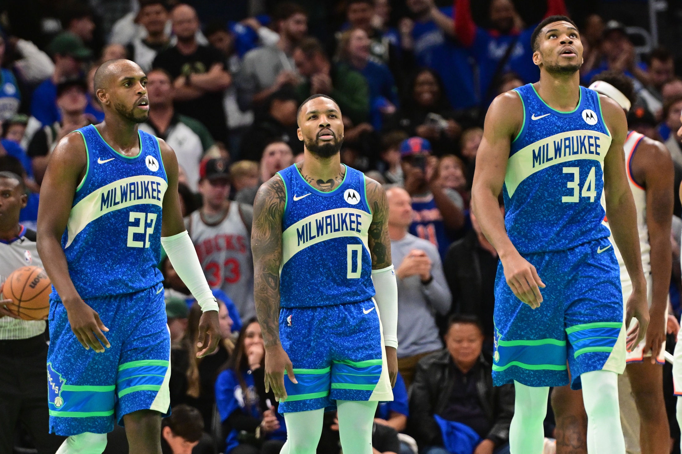 Milwaukee Bucks center Khris Middleton (22), guard Damian Lillard (0) and forward Giannis Antetokounmpo (34) looks on during a timeout in the fourth quarter against the New York Knicks at Fiserv Forum.