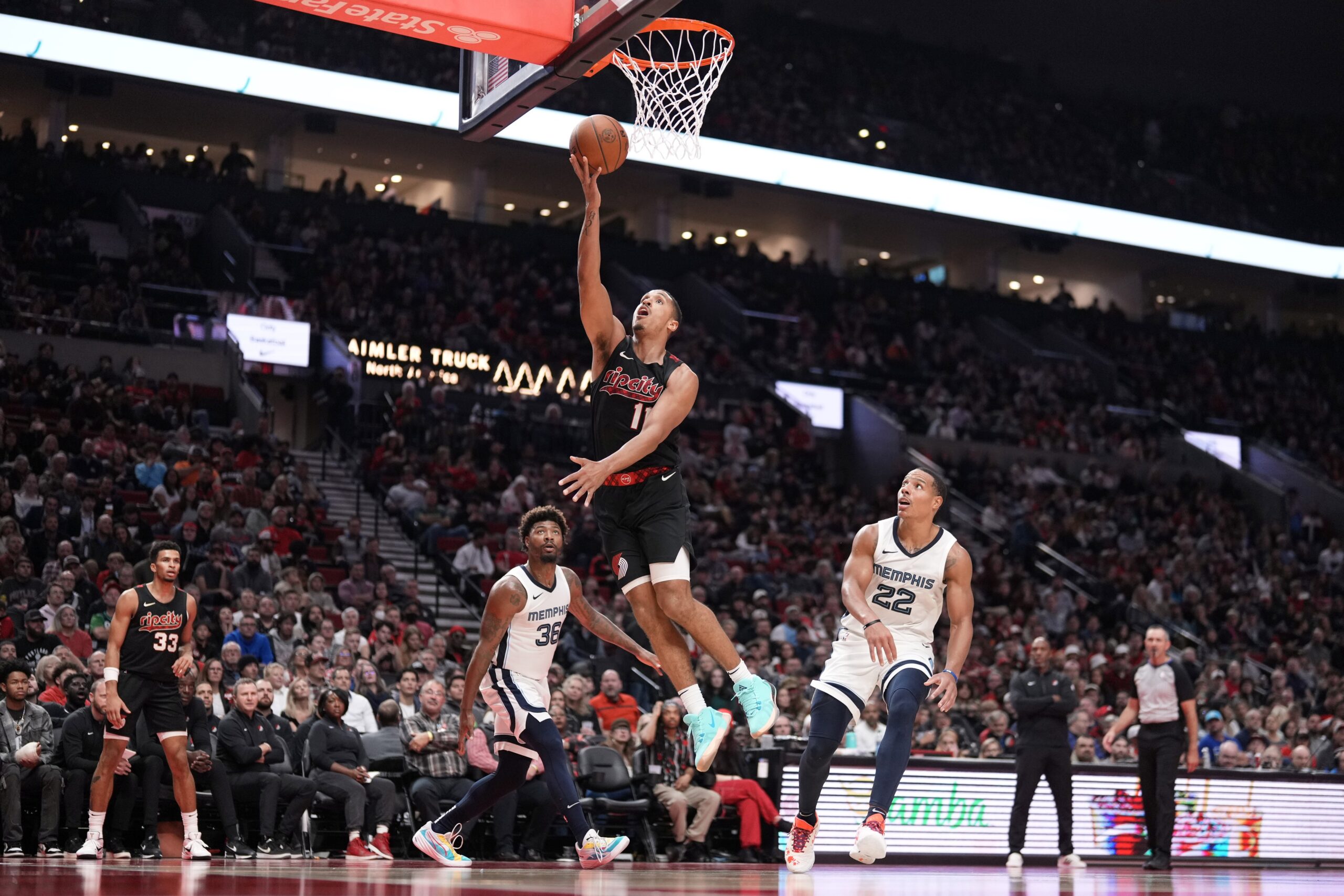 ortland Trail Blazers point guard Malcolm Brogdon (11) shoots the ball as Memphis Grizzlies point guard Marcus Smart (36) and Desmond Bane (22) look on during the second half at Moda Center.