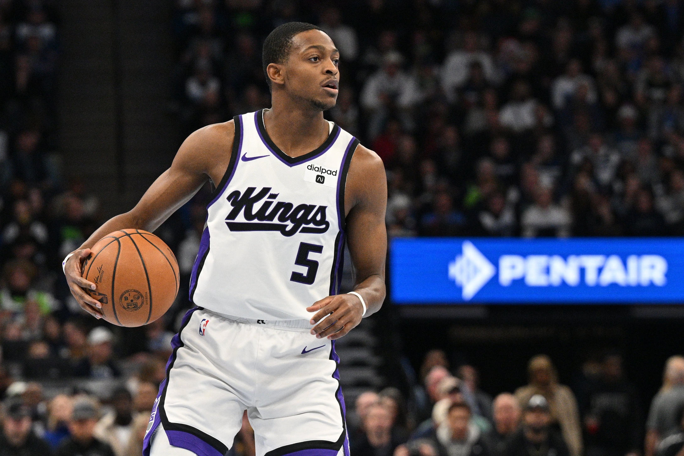 Sacramento Kings guard De'Aaron Fox (5) handles the ball against the Minnesota Timberwolves during the first quarter at Target Center.