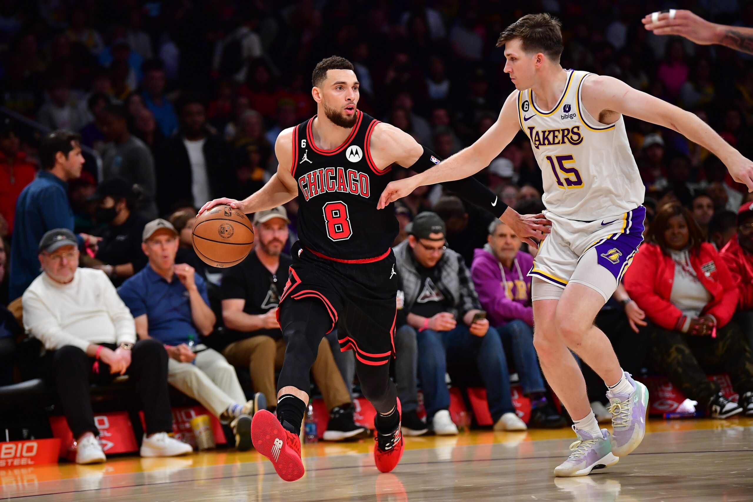 Mar 26, 2023; Los Angeles, California, USA; Chicago Bulls guard Zach LaVine (8) moves the ball up court against Los Angeles Lakers guard Austin Reaves (15) during the second half at Crypto.com Arena. Mandatory Credit: Gary A. Vasquez-USA TODAY Sports