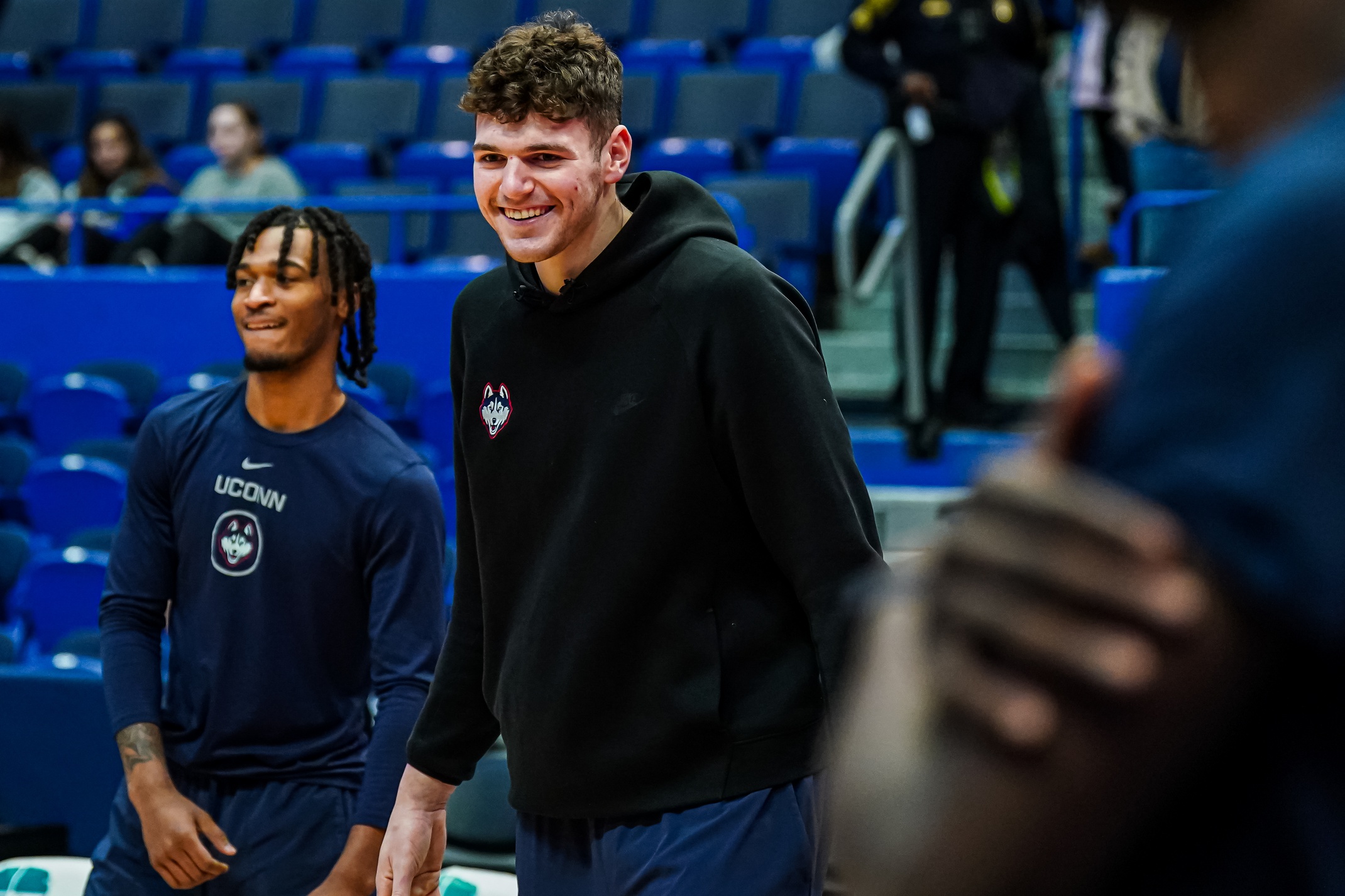 Dec 23, 2023; Hartford, Connecticut, USA; Connecticut Huskies center Donovan Clingan (32) watches from the sideline as teammates warm up before the start of the game against the St. John's Red Storm at XL Center. Mandatory Credit: David Butler II-USA TODAY Sports