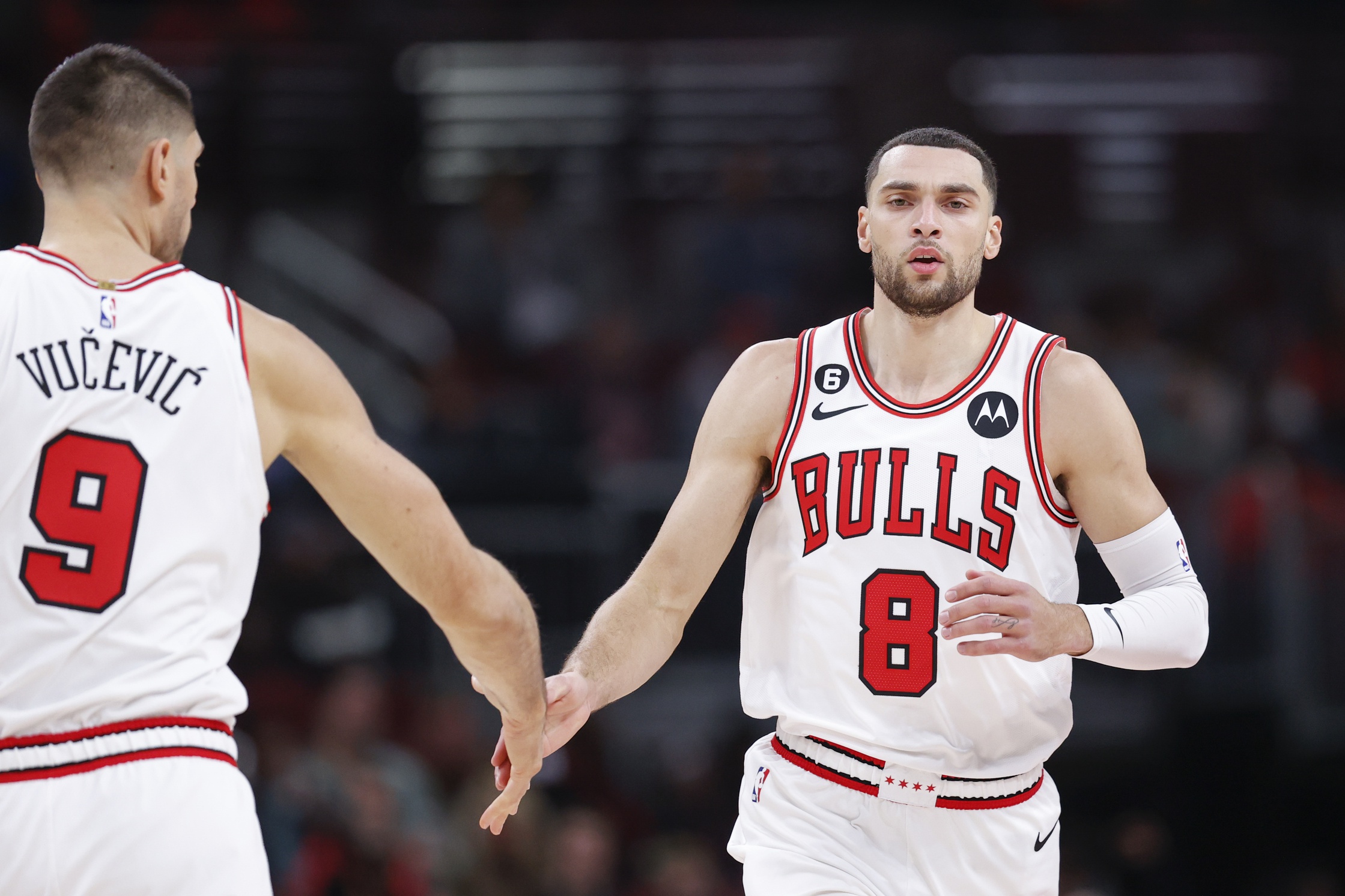 Chicago Bulls guard Zach LaVine (8) is congratulated by center Nikola Vucevic (9) after scoring against the Washington Wizards during the first half at United Center.