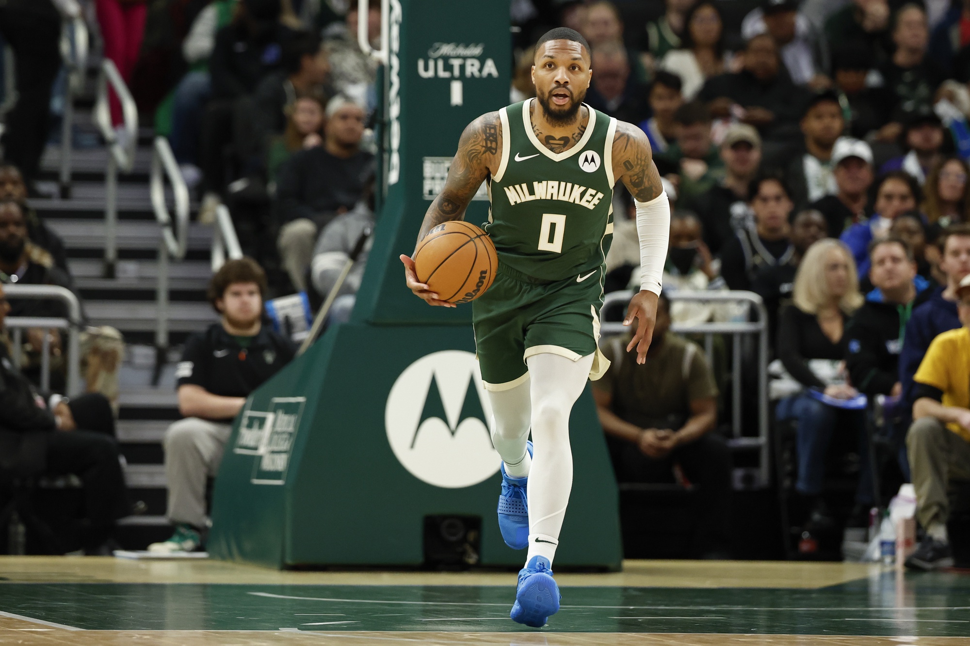 Milwaukee Bucks guard Damian Lillard (0) brings the ball up court against the Indiana Pacers during the first half at Fiserv Forum.