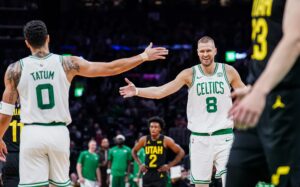 Boston Celtics center Kristaps Porzingis (8) and forward Jayson Tatum (0) react after a play against the Utah Jazz in the second quarter at TD Garden.