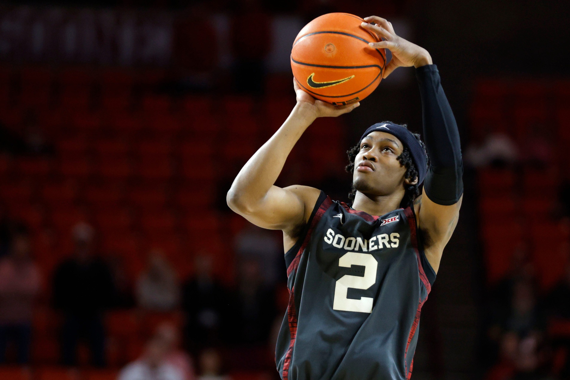 Oklahoma Sooners guard Javian McCollum (2) makes a 3-pointer during a college basketball game between the University of Oklahoma Sooners (OU) and the West Virginia Mountaineers at Lloyd Noble Center