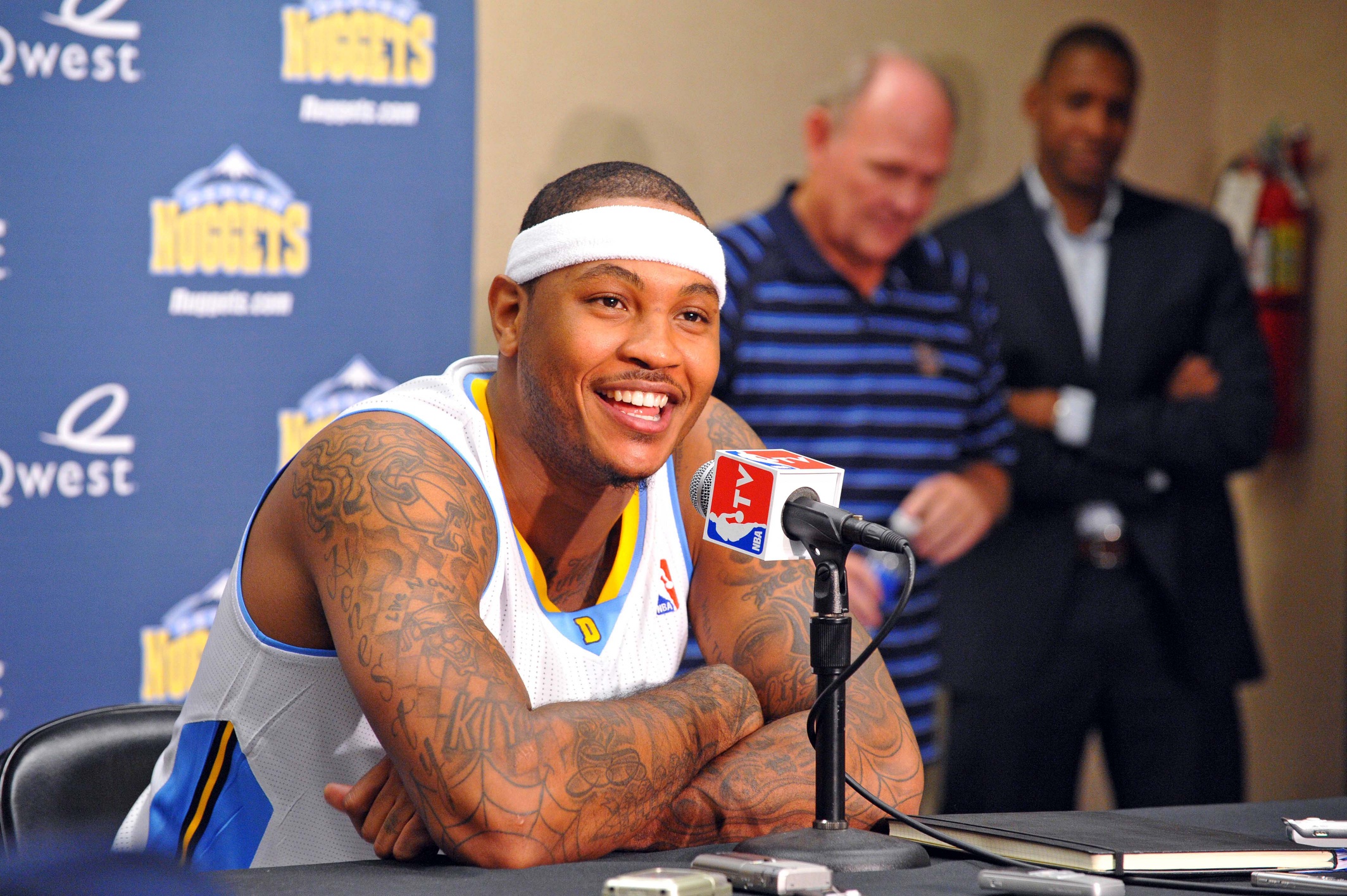 Sept 27, 2010; Denver, CO, USA; Denver Nuggets forward Carmelo Anthony (left) speaks during a press conference as general manager Masai Ujiri (right) and head coach George Karl listen during media day at the Pepsi Center. Mandatory Credit: Ron Chenoy-USA TODAY Sports