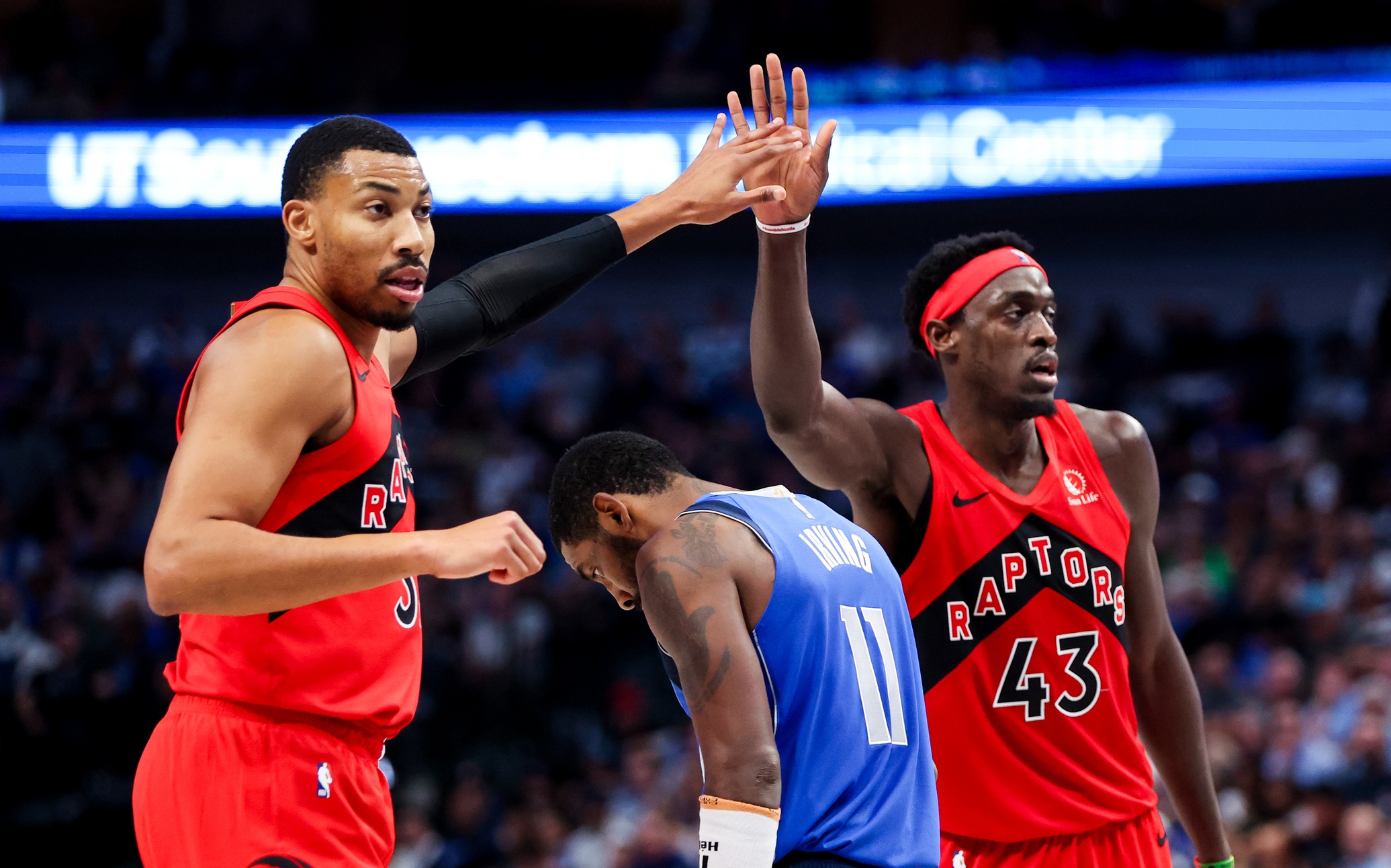 Nov 8, 2023; Dallas, Texas, USA; Toronto Raptors forward Otto Porter Jr. (32) and Toronto Raptors forward Pascal Siakam (43) celebrate over Dallas Mavericks guard Kyrie Irving (11) during the second half at American Airlines Center. Mandatory Credit: Kevin Jairaj-USA TODAY Sports