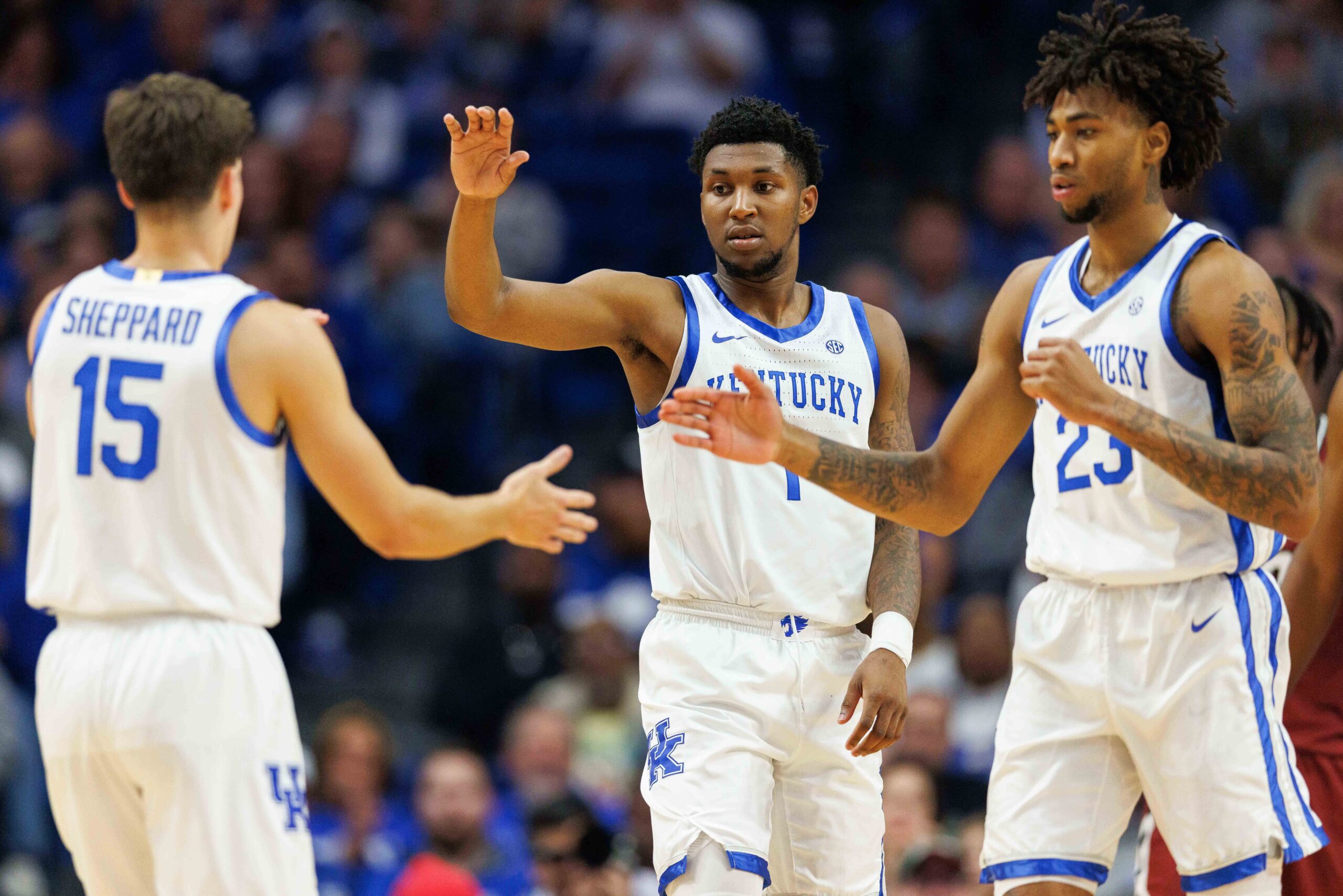 Kentucky Wildcats guard Reed Sheppard shakes hands with teammates