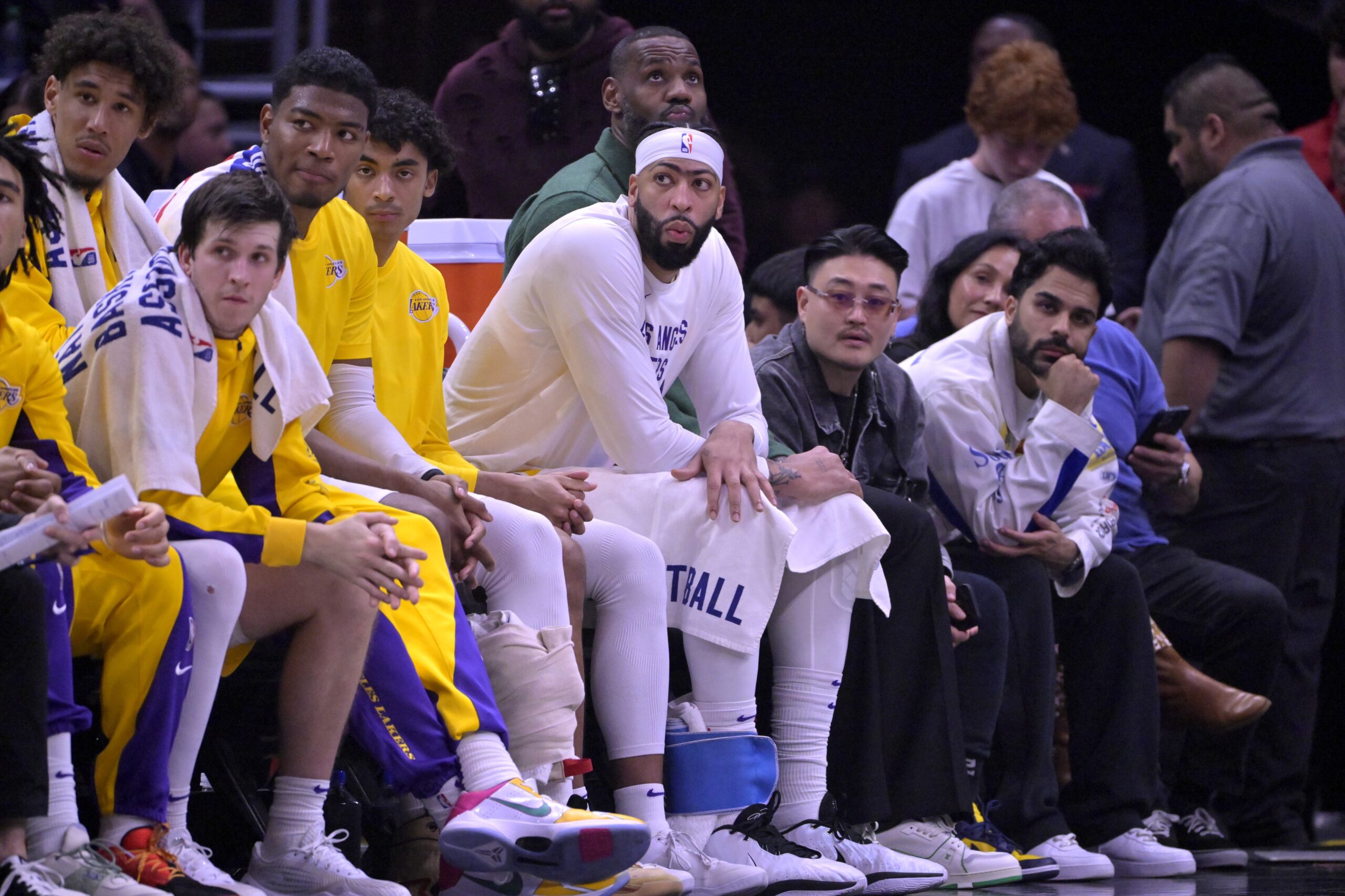 Jan 23, 2024; Los Angeles, California, USA; Los Angeles Lakers guard Jalen Hood-Schifino (0) and guard Austin Reaves (15) and forward Rui Hachimura (28) and guard Max Christie (10) forward Anthony Davis (3) and forward LeBron James (23) look on from the bench in the second half against the Los Angeles Clippers at Crypto.com Arena. Mandatory Credit: Jayne Kamin-Oncea-USA TODAY Sports