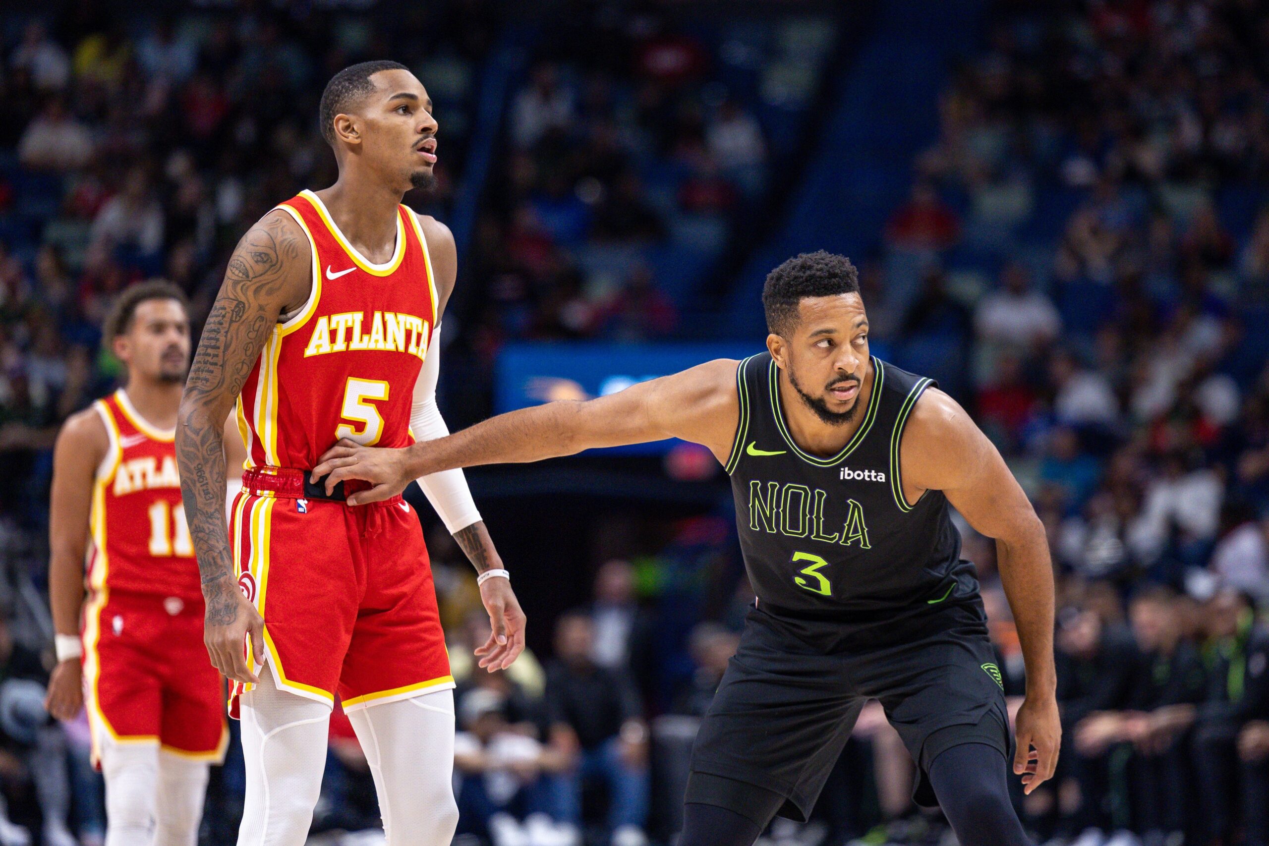 New Orleans Pelicans guard CJ McCollum (3) guards Atlanta Hawks guard Dejounte Murray (5) during the first half at Smoothie King Center.