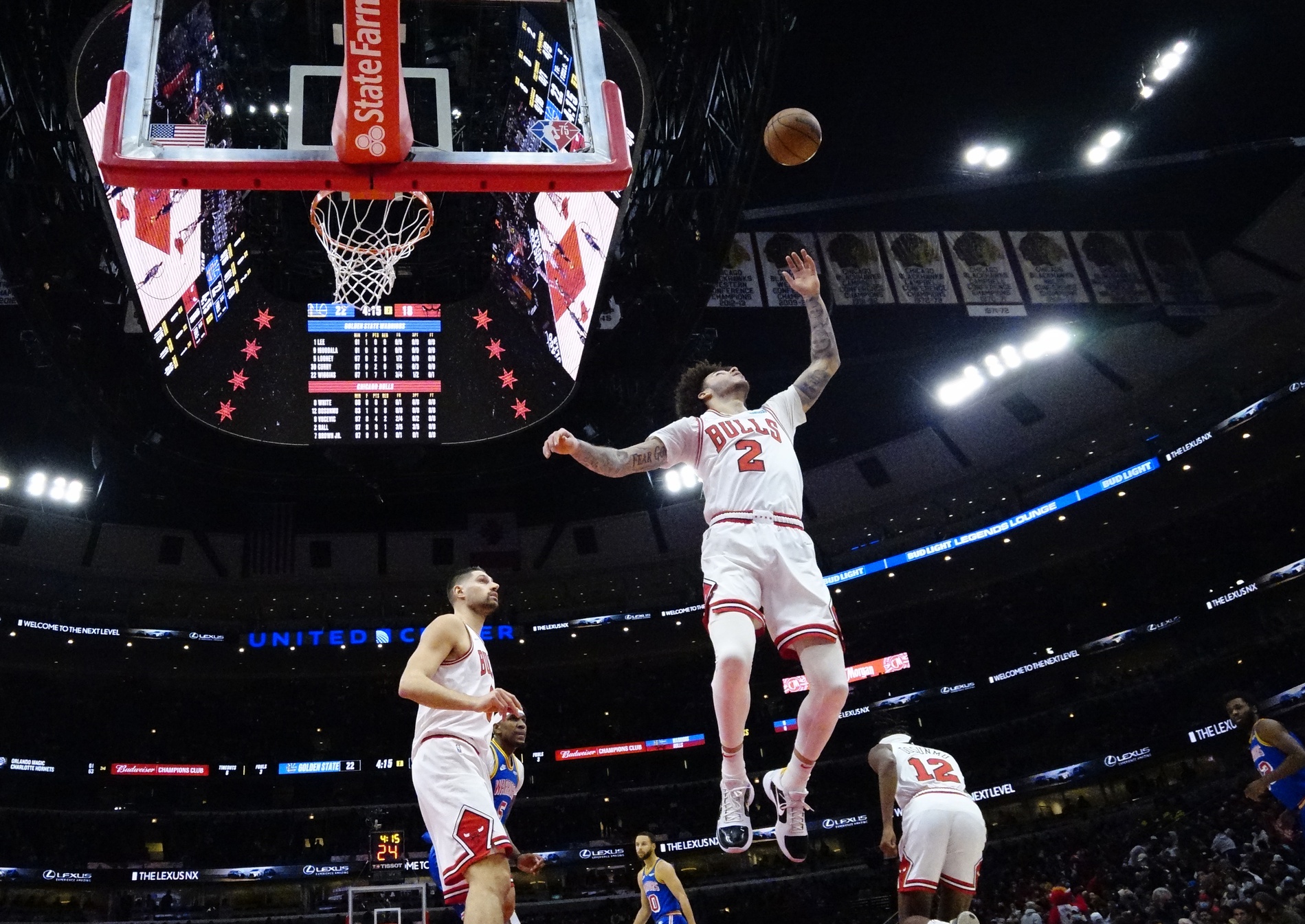 Chicago Bulls point guard Lonzo Ball goes up for a rebound as Nikola Vucevic watches