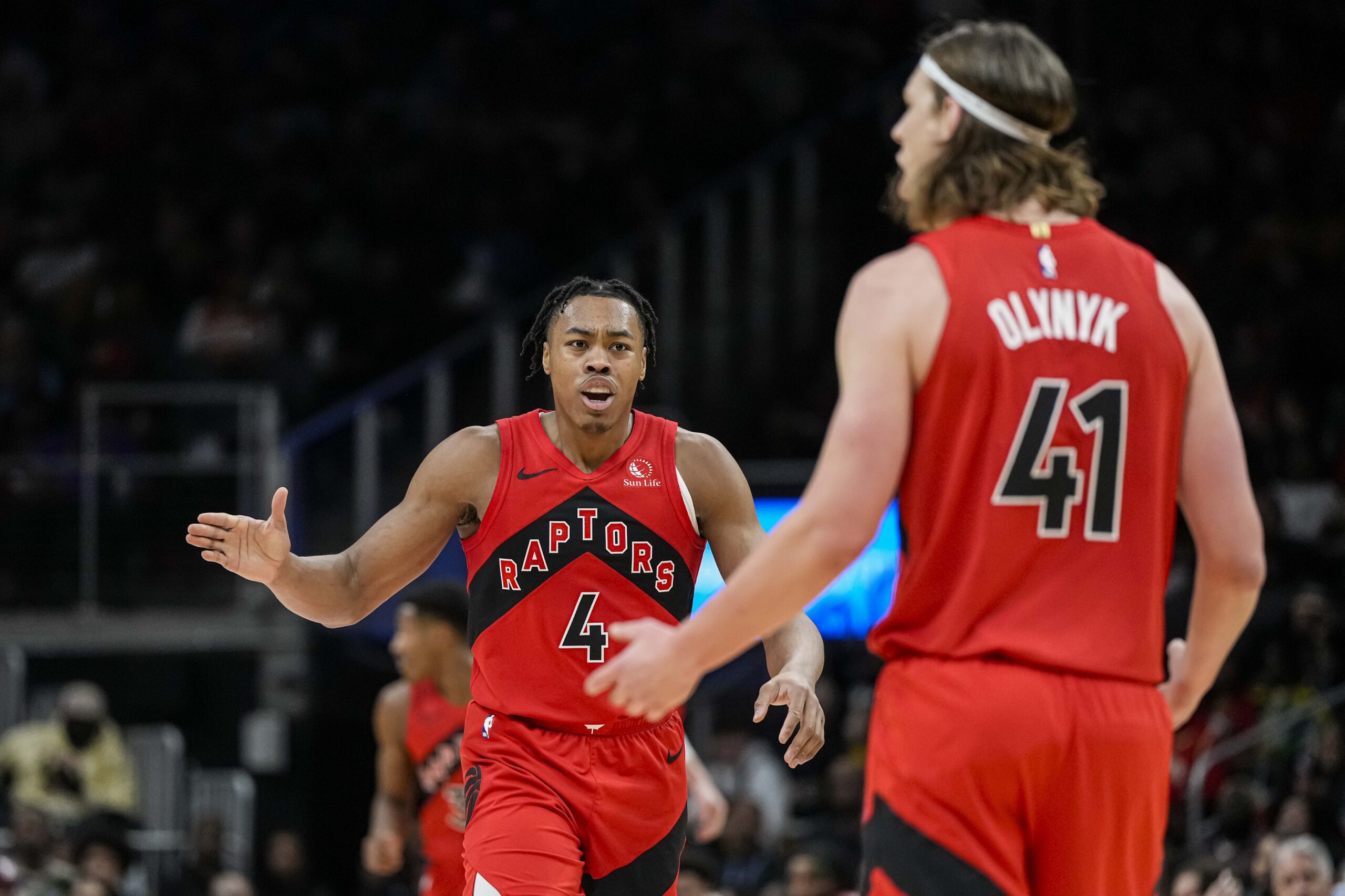 Feb 23, 2024; Atlanta, Georgia, USA; Toronto Raptors forward Scottie Barnes (4) reacts with forward Kelly Olynyk (41) after a Toronto basket against the Atlanta Hawks during the first half at State Farm Arena. Mandatory Credit: Dale Zanine-USA TODAY Sports