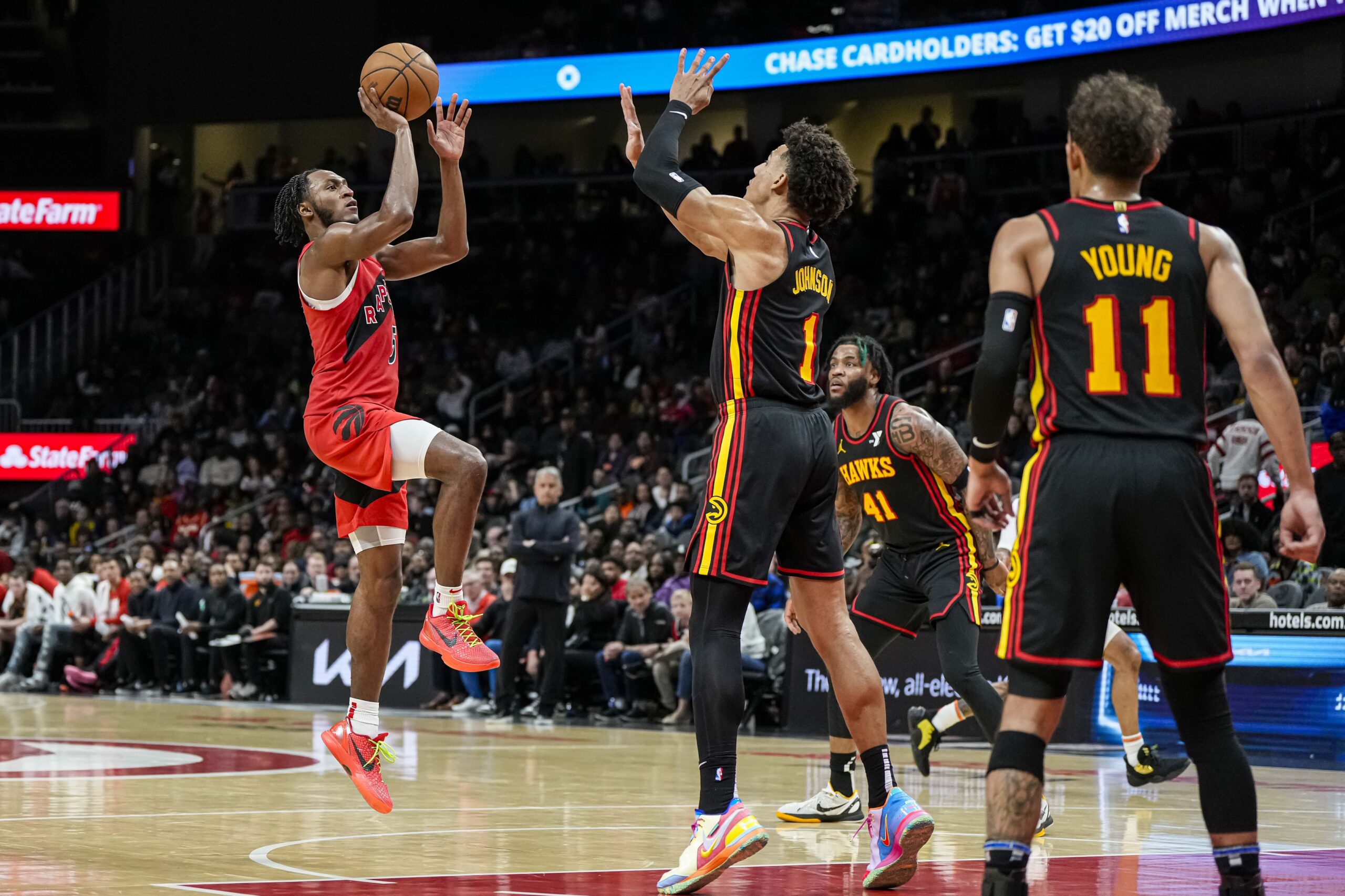 Toronto Raptors guard Immanuel Quickley (5) shoots against Atlanta Hawks forward Jalen Johnson (1) during the second half at State Farm Arena.