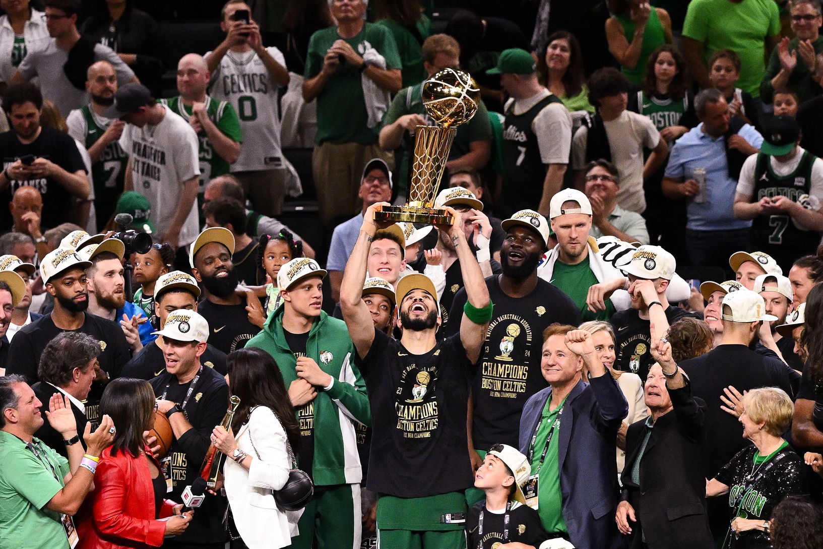 Boston Celtics forward Jayson Tatum (0) holds up the Larry O'Brien Championship Trophy after the Celtics beat the Dallas Mavericks in game five of the 2024 NBA Finals at the TD Garden.