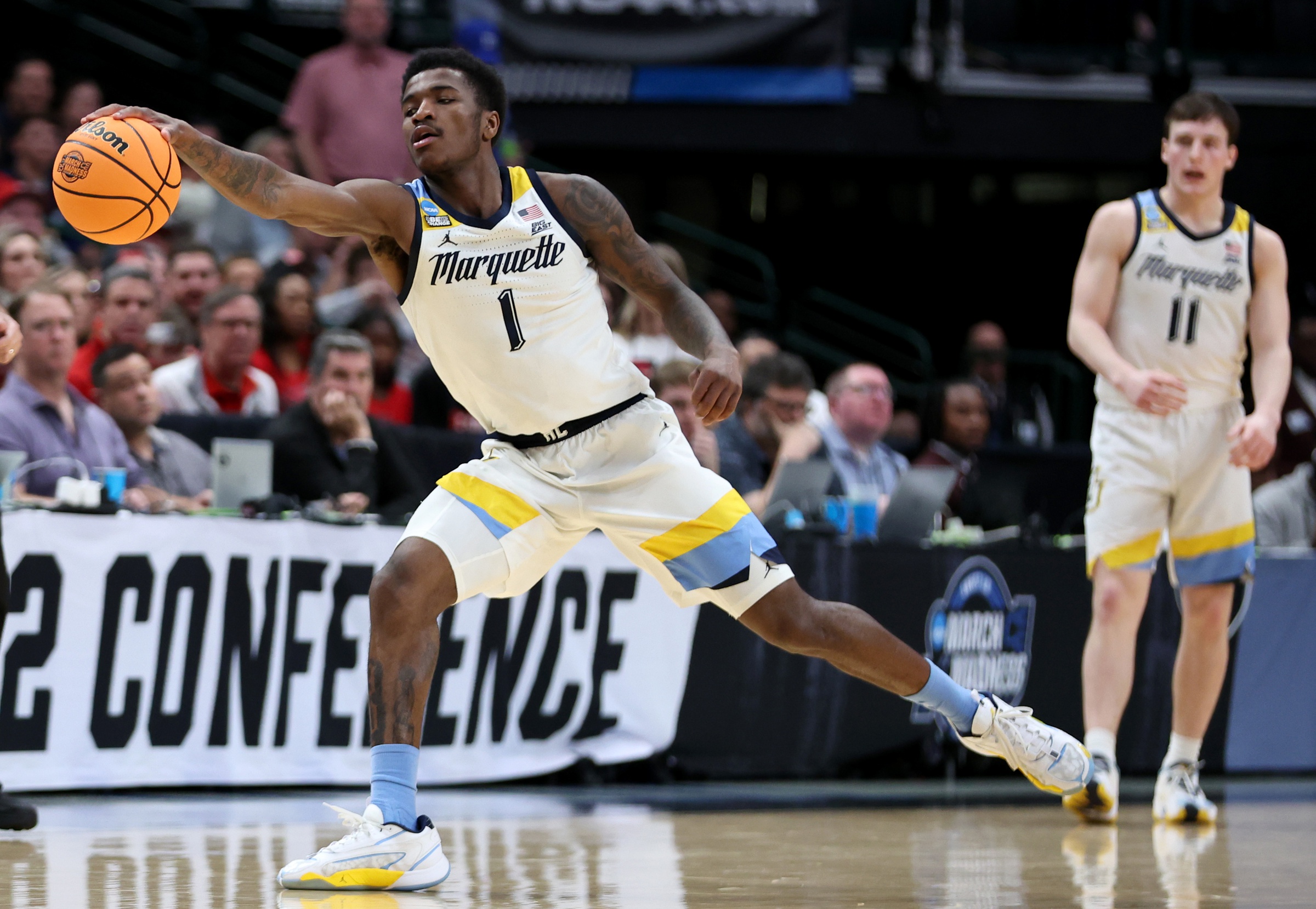 Mar 29, 2024; Dallas, TX, USA; Marquette Golden Eagles guard Kam Jones (1) grabs a loose ball during the first half in the semifinals of the South Regional of the 2024 NCAA Tournament against the North Carolina State Wolfpack at American Airlines Center. Mandatory Credit: Tim Heitman-USA TODAY Sports