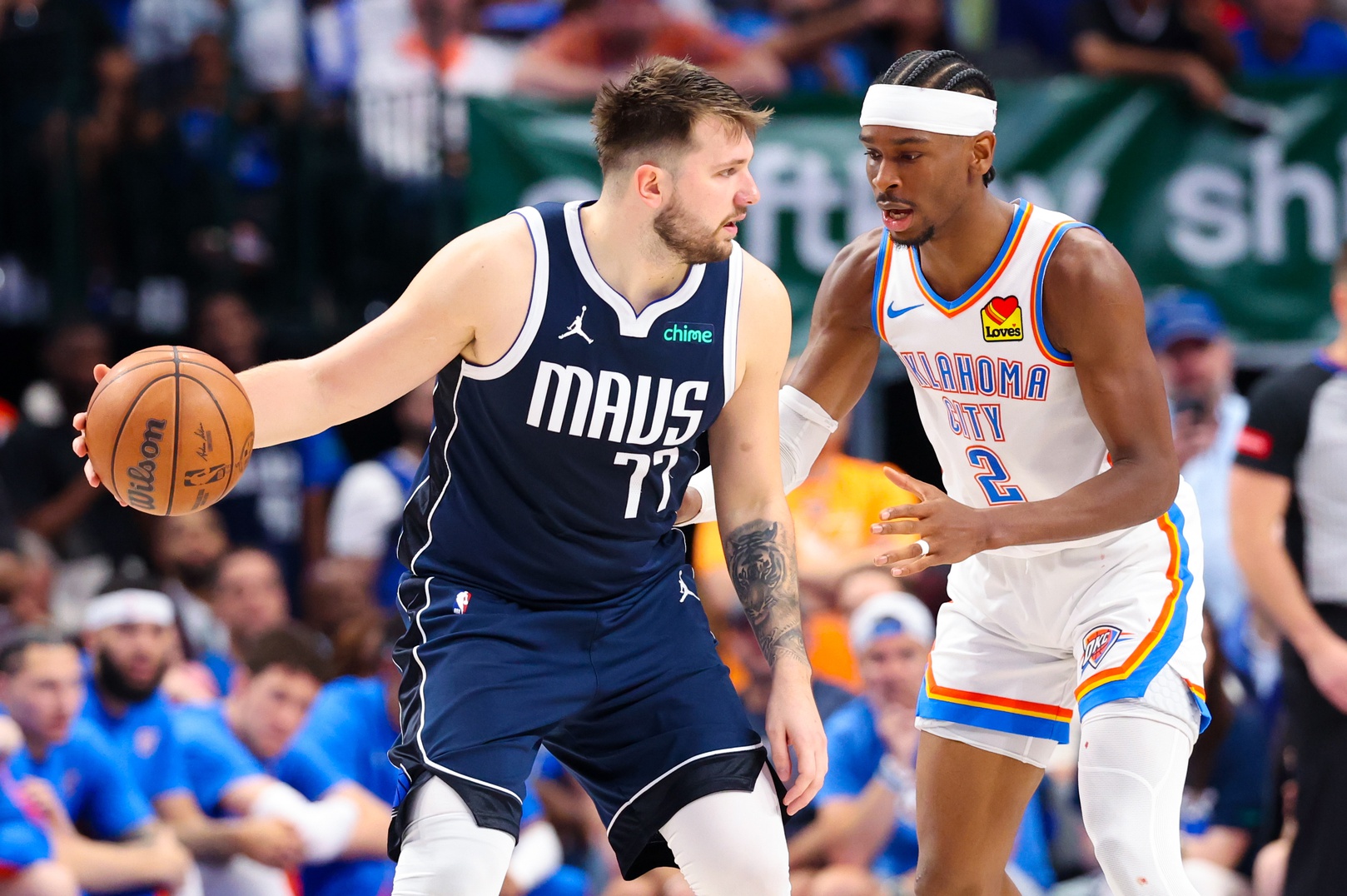 Dallas Mavericks guard Luka Doncic (77) controls the ball as Oklahoma City Thunder guard Shai Gilgeous-Alexander (2) defends during the second half during game three of the second round for the 2024 NBA playoffs at American Airlines Center.