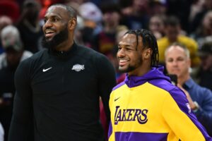 Los Angeles Lakers guard Bronny James, right, and forward LeBron James warm up