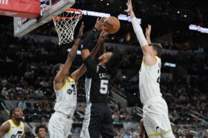 Utah Jazz rookie Cody Williams blocks San Antonio Spurs rookie Stephon Castle