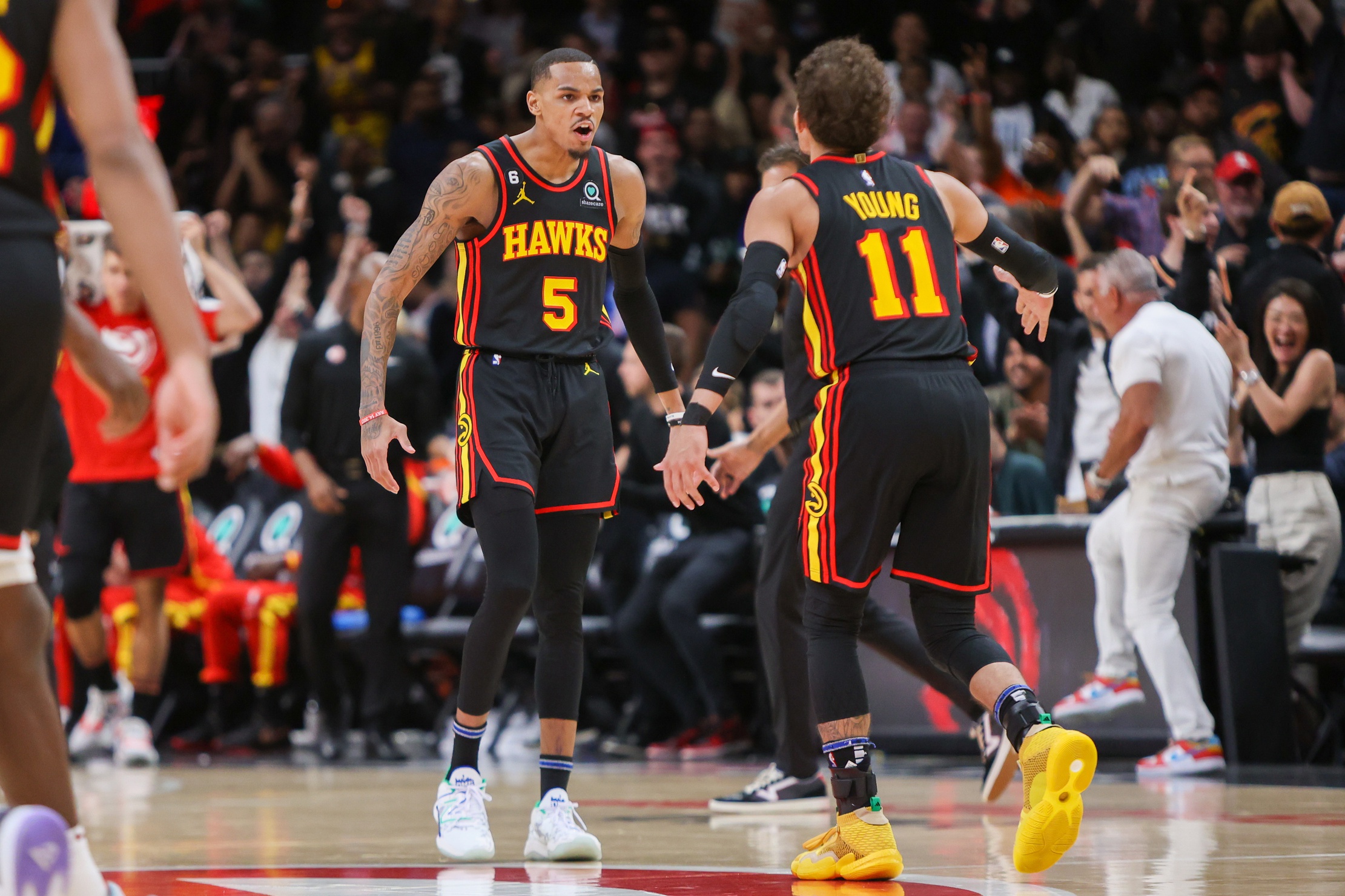 Atlanta Hawks guard Dejounte Murray (5) reacts with guard Trae Young (11) — prior to New Orleans Pelicans trade