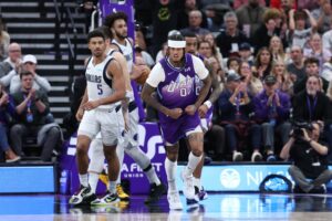 Utah Jazz guard Jordan Clarkson (00) reacts to a basket with center John Collins (20) behind him