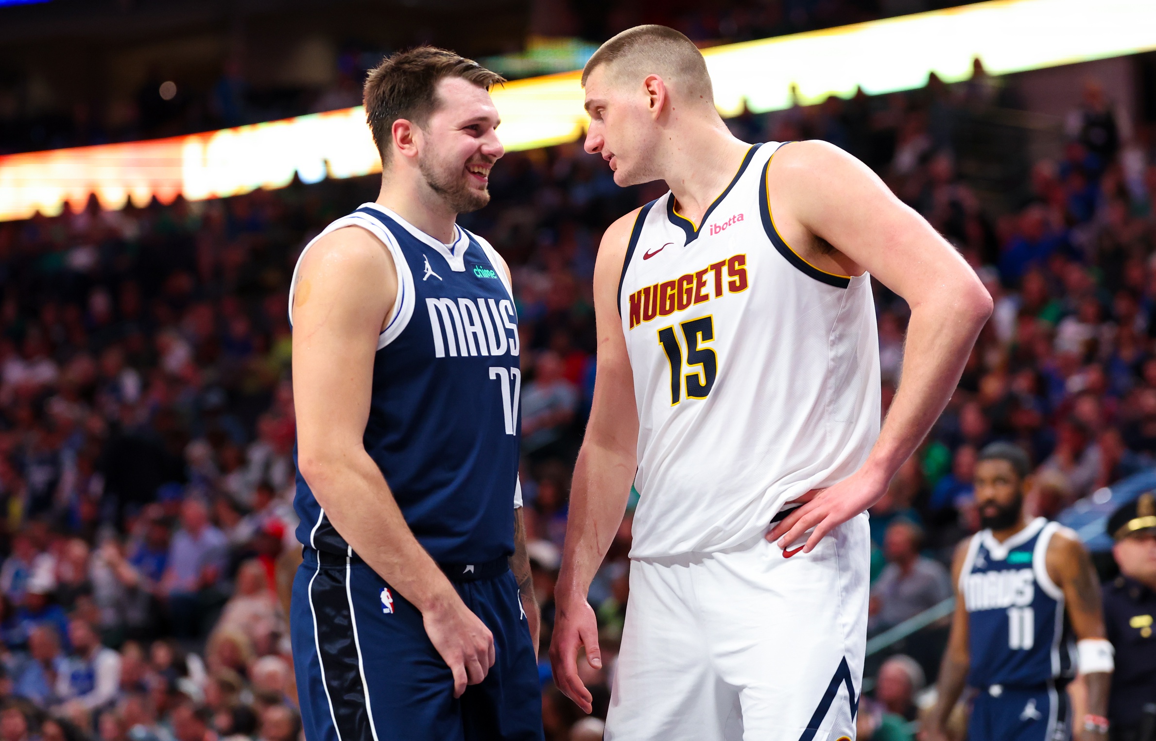 Dallas Mavericks guard Luka Doncic (77) speaks with Denver Nuggets center Nikola Jokic (15)