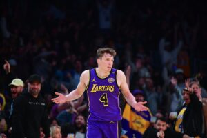 Los Angeles Lakers guard Dalton Knecht (4) shrugs shoulders after scoring a three