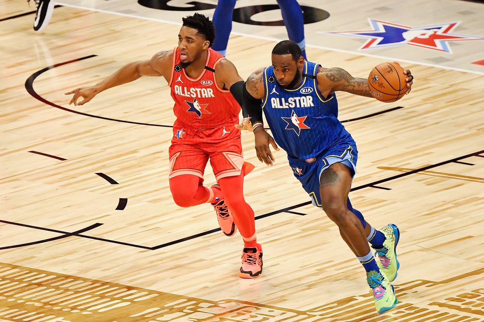 Team LeBron forward LeBron James of the Los Angeles Lakers dribbles past Team Giannis guard Donovan Mitchell of the Cleveland Cavaliers