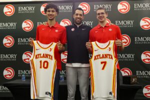 Atlanta Hawks first overall draft pick Zaccharie Risacher and general manager Landry Fields and second round draft pick Nikola Djurisic pose for a photo with jerseys