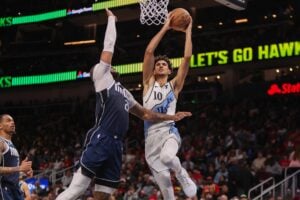 Atlanta Hawks forward Zaccharie Risacher (10) is defended by Dallas Mavericks center Daniel Gafford (21)