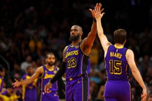 Los Angeles Lakers forward LeBron James (23) celebrates with guard Austin Reaves