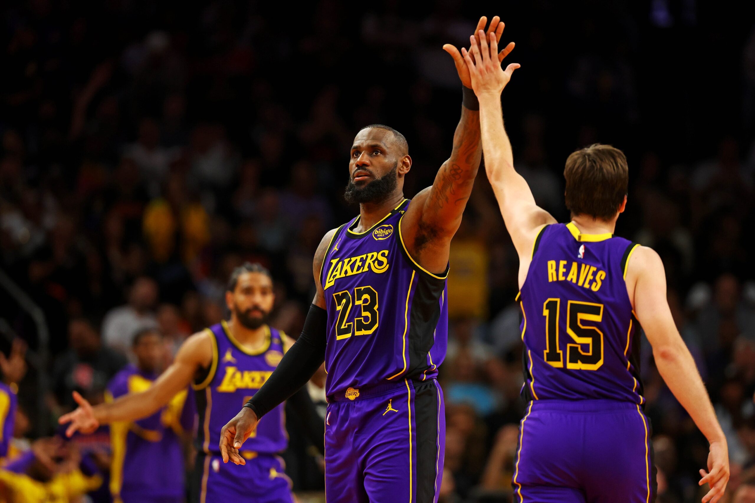 Los Angeles Lakers forward LeBron James (23) celebrates with guard Austin Reaves