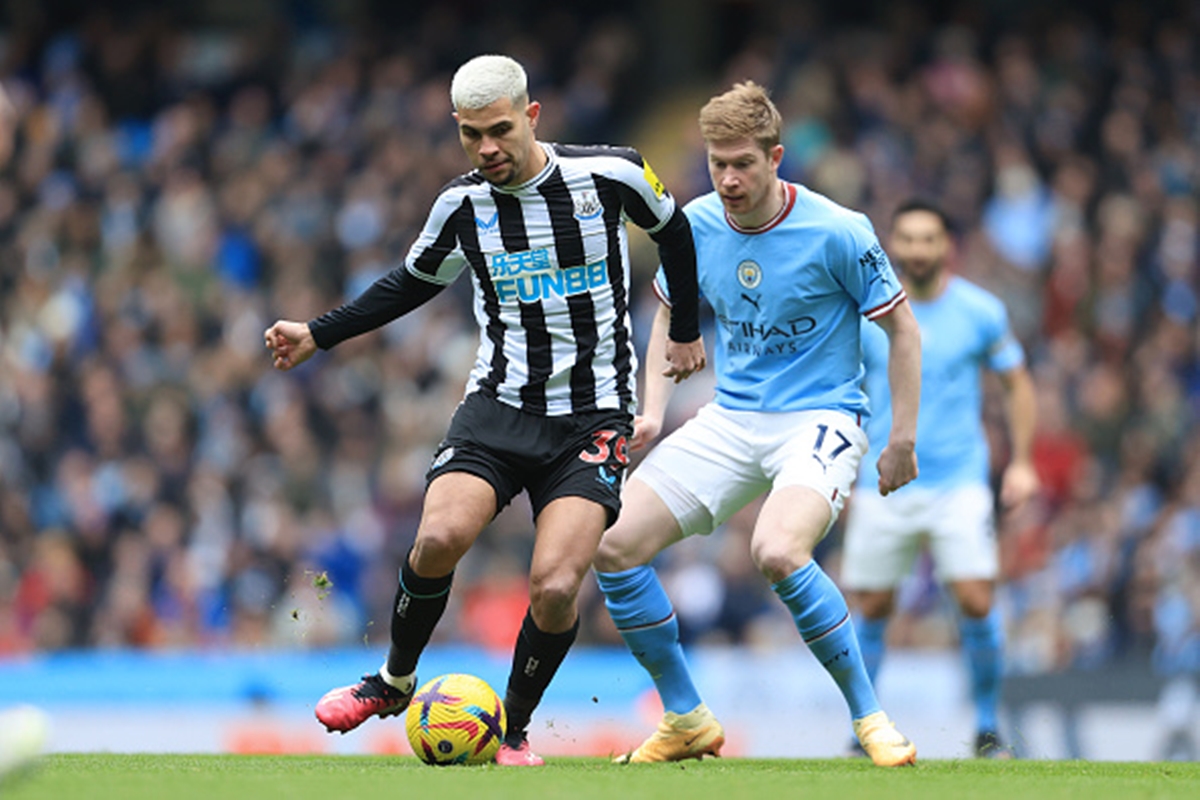 Bruno Guimaraes competes for the ball against Manchester City