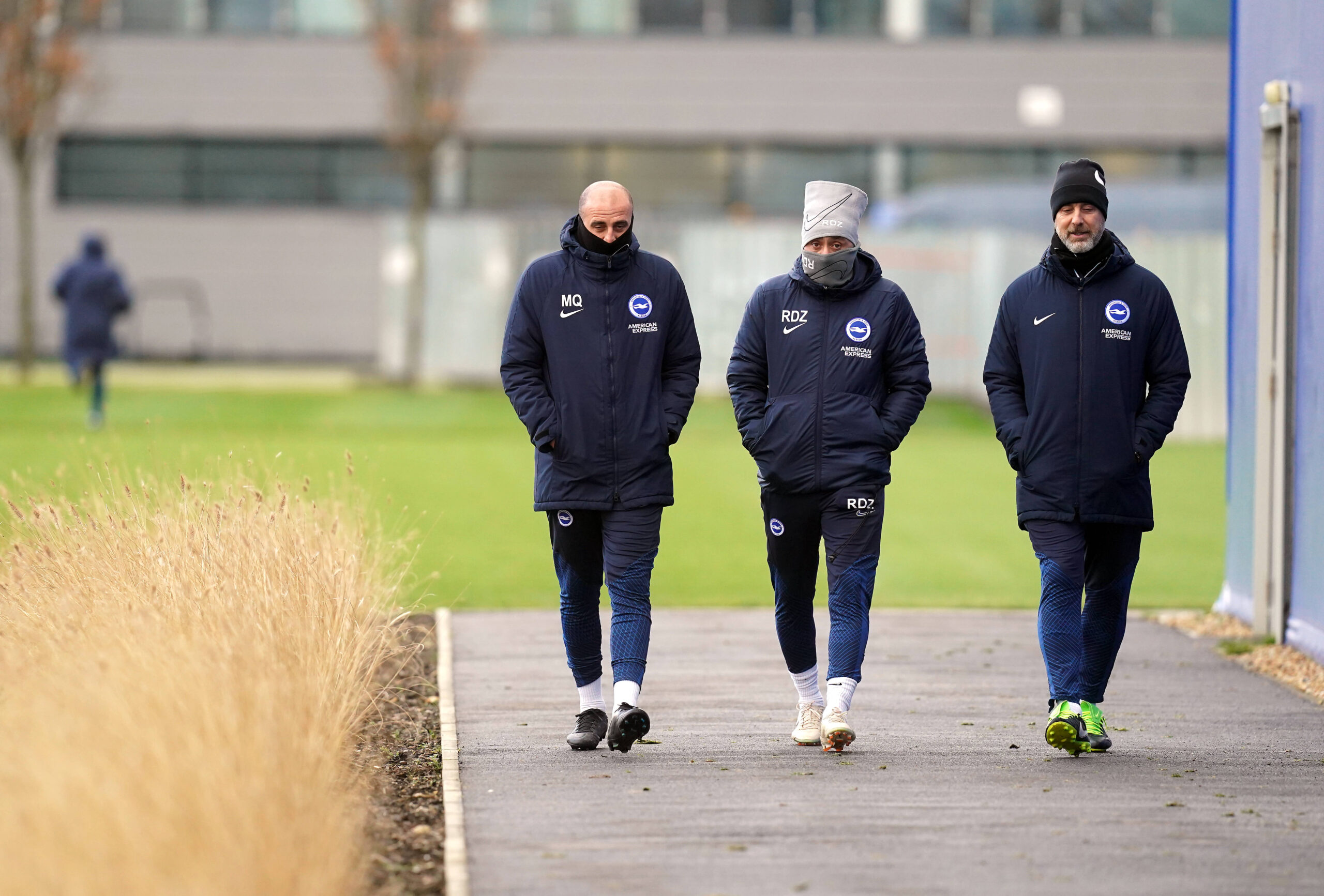 Roberto De Zerbi and assistants on the ground during training session