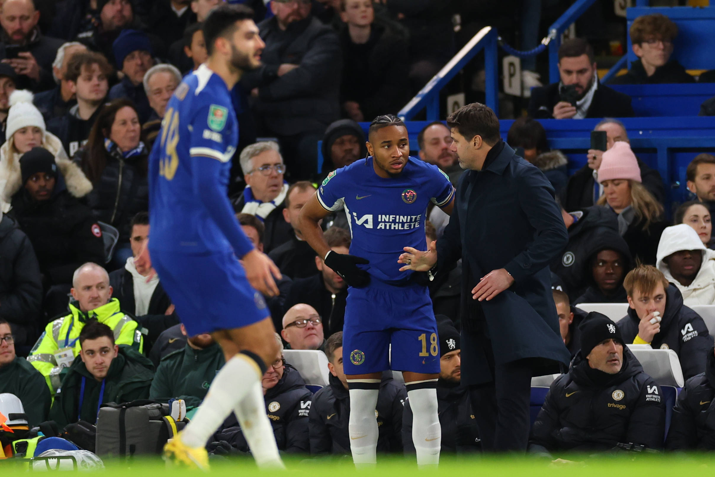 Christopher Nkunku receiving instructions from manager Mauricio Pochettino before being subbed on