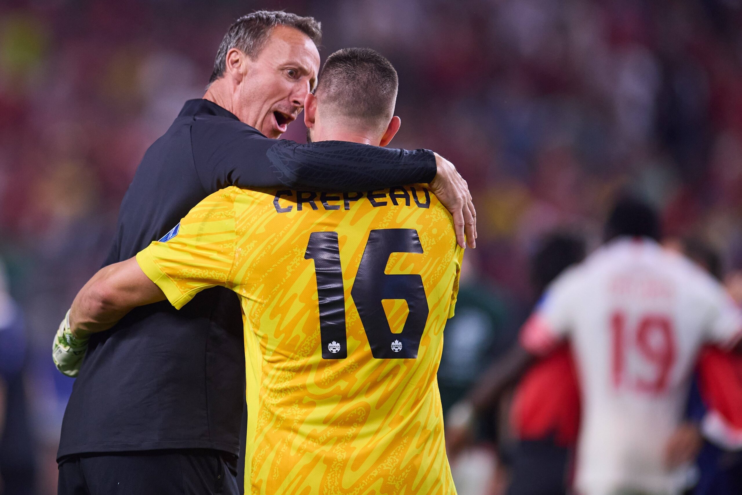 Canada manager Jesse Marsch speaking with goalkeeper Maxime Crepeau