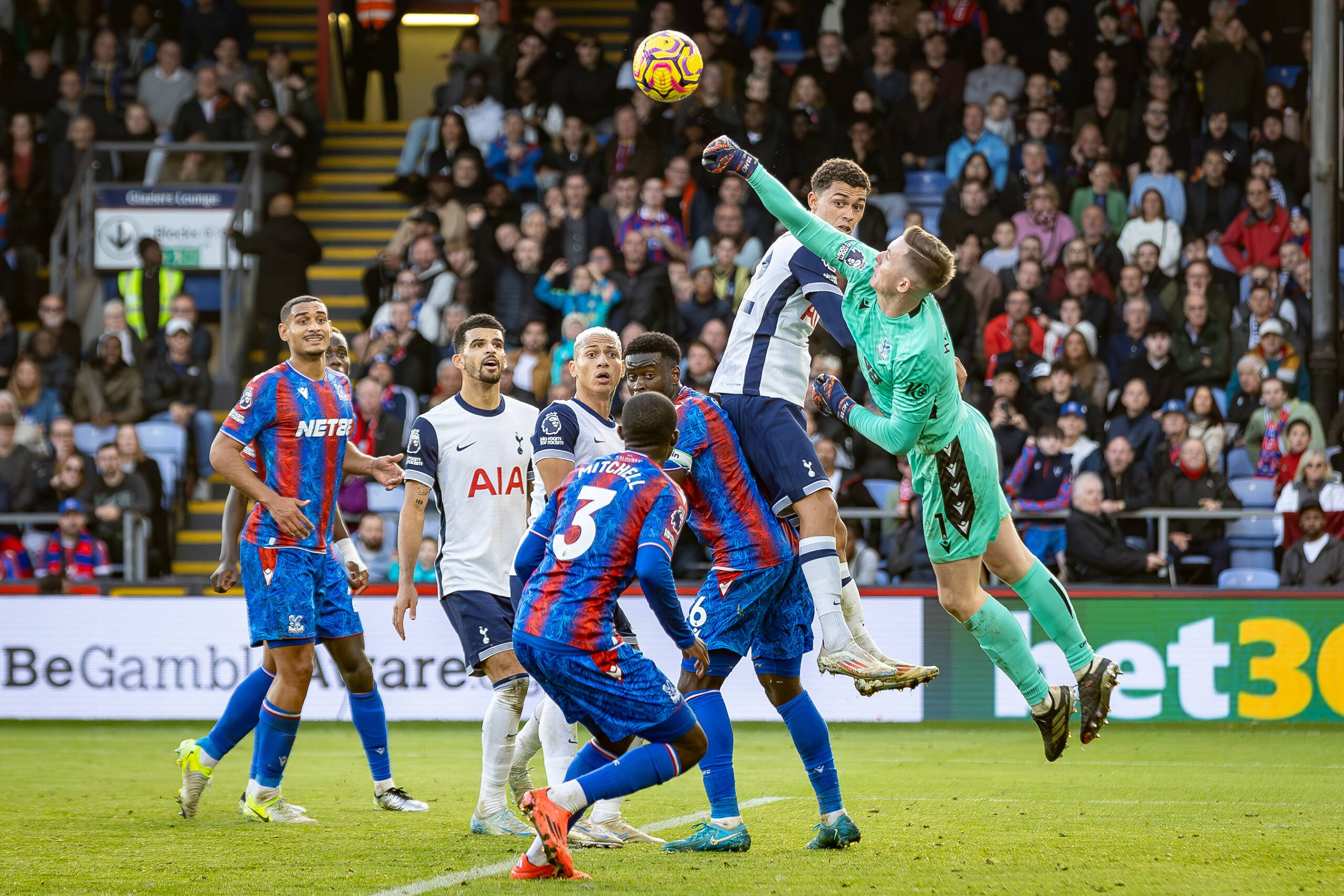 Dean Henderson punches the ball in crowded penalty area