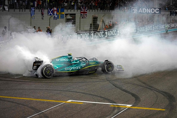 TOPSHOT - Aston Martin's German driver Sebastian Vettel performs a doughnut on the track after the Abu Dhabi Formula One Grand Prix at the Yas Marina Circuit in the Emirati city of Abu Dhabi on November 20, 2022. (Photo by Kamran Jebreili / POOL / AFP) (Photo by KAMRAN JEBREILI/POOL/AFP via Getty Images)