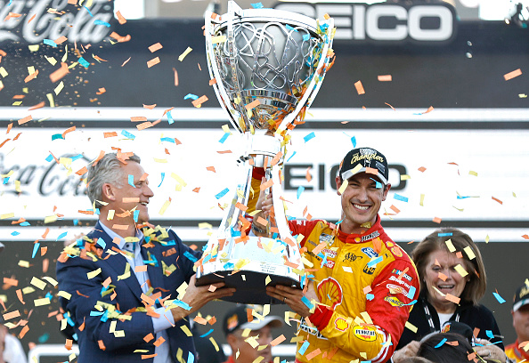 AVONDALE, ARIZONA - NOVEMBER 06: NASCAR President Steve Phelps presents the Bill France NASCAR Cup Series Championship trophy to Joey Logano, driver of the #22 Shell Pennzoil Ford, in victory lane after winning the 2022 NASCAR Cup Series Championship at Phoenix Raceway on November 06, 2022 in Avondale, Arizona. (Photo by Sean Gardner/Getty Images)