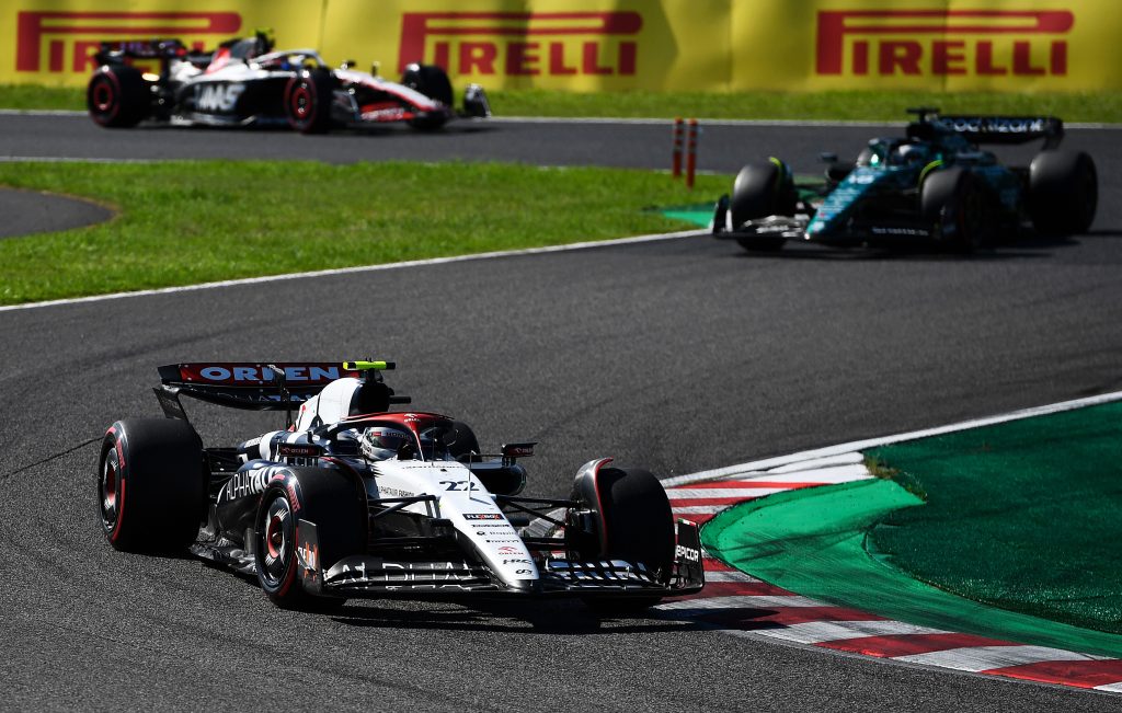 Yuki Tsunoda of Japan driving the (22) Scuderia AlphaTauri AT04 leads Lance Stroll of Canada driving the (18) Aston Martin AMR23 Mercedes during the F1 Grand Prix of Japan at Suzuka International Racing Course.