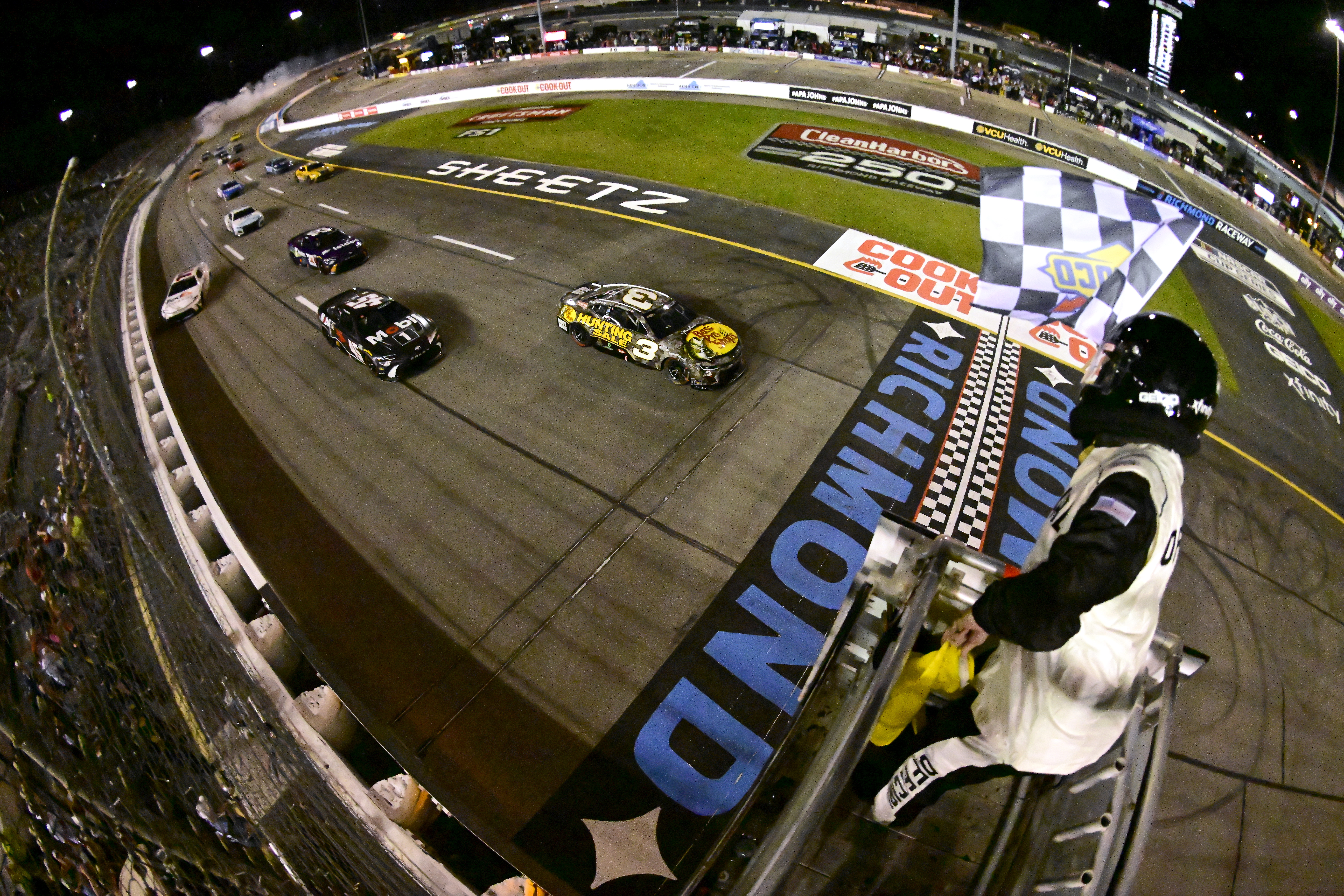 RICHMOND, VIRGINIA - AUGUST 11: Austin Dillon, driver of the #3 Bass Pro Shops Chevrolet, takes the checkered flag under caution to win the NASCAR Cup Series Cook Out 400 at Richmond Raceway on August 11, 2024 in Richmond, Virginia. (Photo by Logan Whitton/Getty Images)