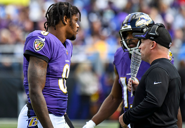 Ravens OC Greg Roman coaches up Lamar Jackson.