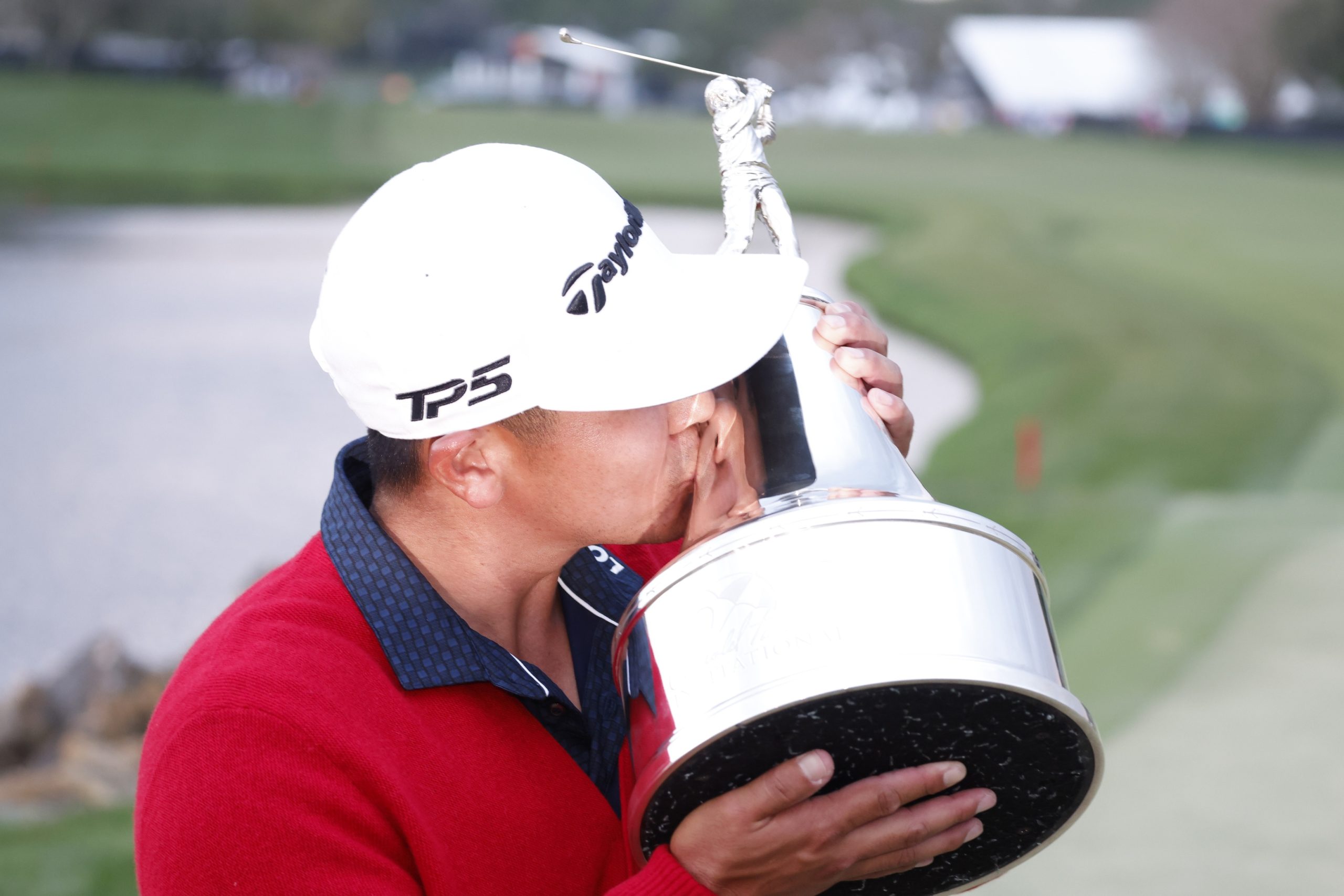 Kurt Kitayama kisses the Arnold Palmer Invitational trophy